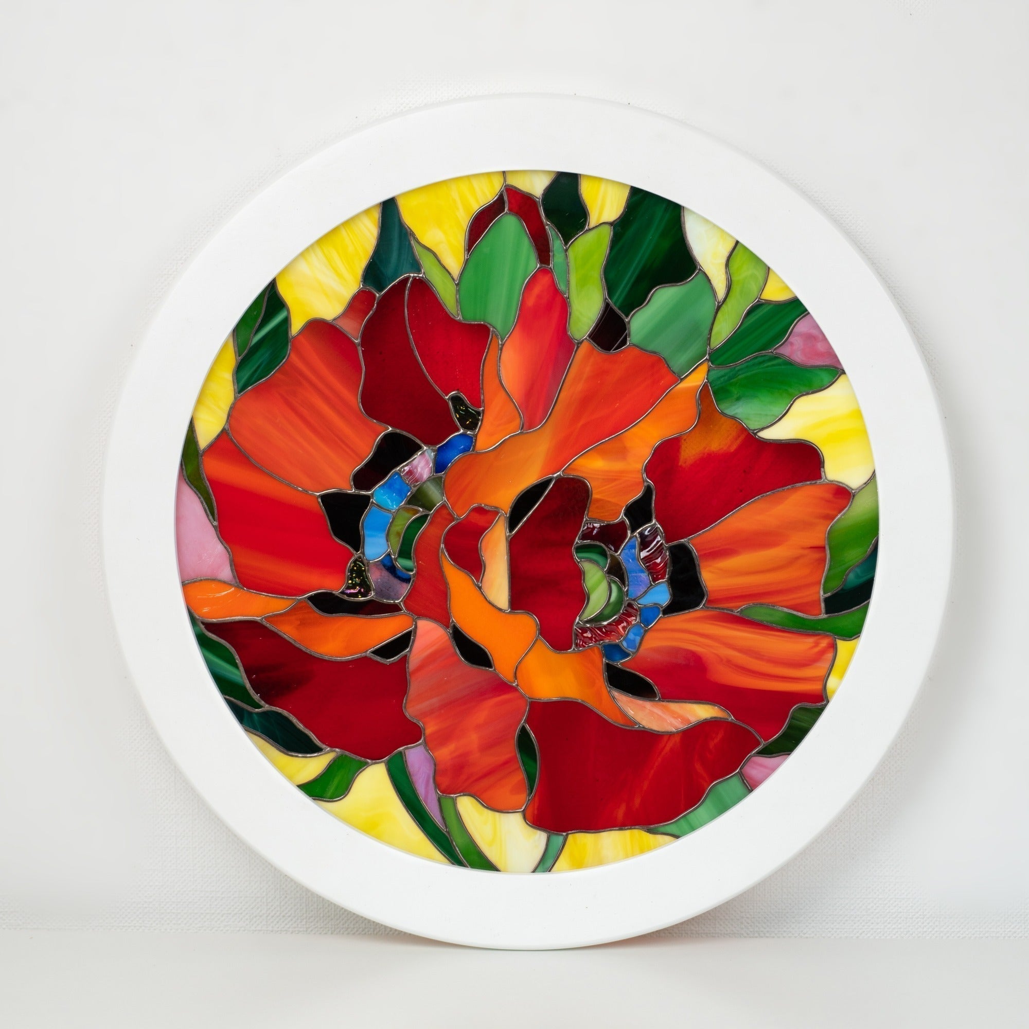 Stained glass artwork with floral design on a white background