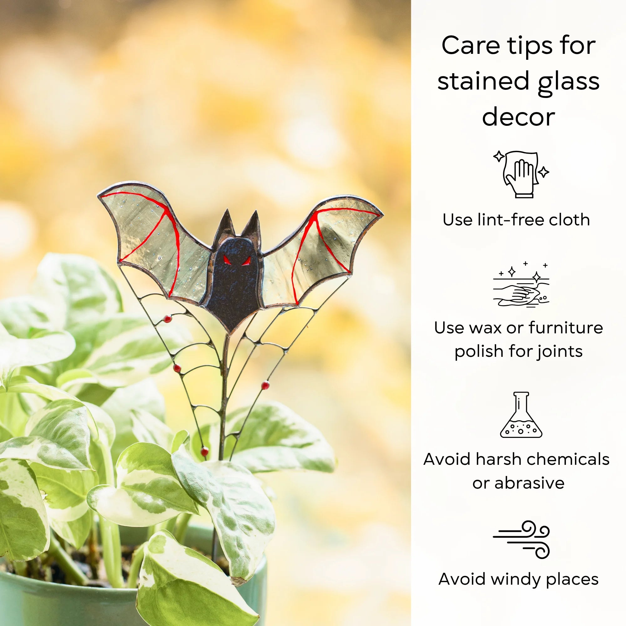 Care tips for stained glass decor beside a red-eyed bat plant stake on a wire web - wipe with a lint-free cloth, wax the joints, avoid harsh chemicals and windy places