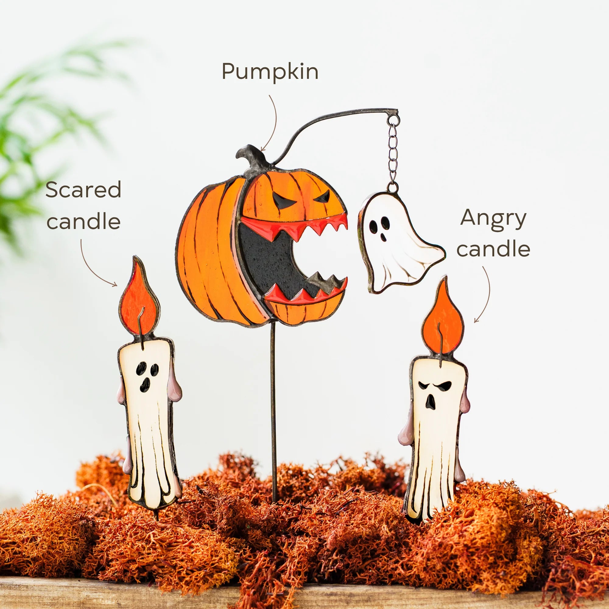 Halloween-themed stained glass set of plant stakes featuring a carved orange pumpkin, two ghost candles labeled 'Scared candle' and 'Angry candle,' and a hanging ghost with a chain labeled 'Pumpkin.'