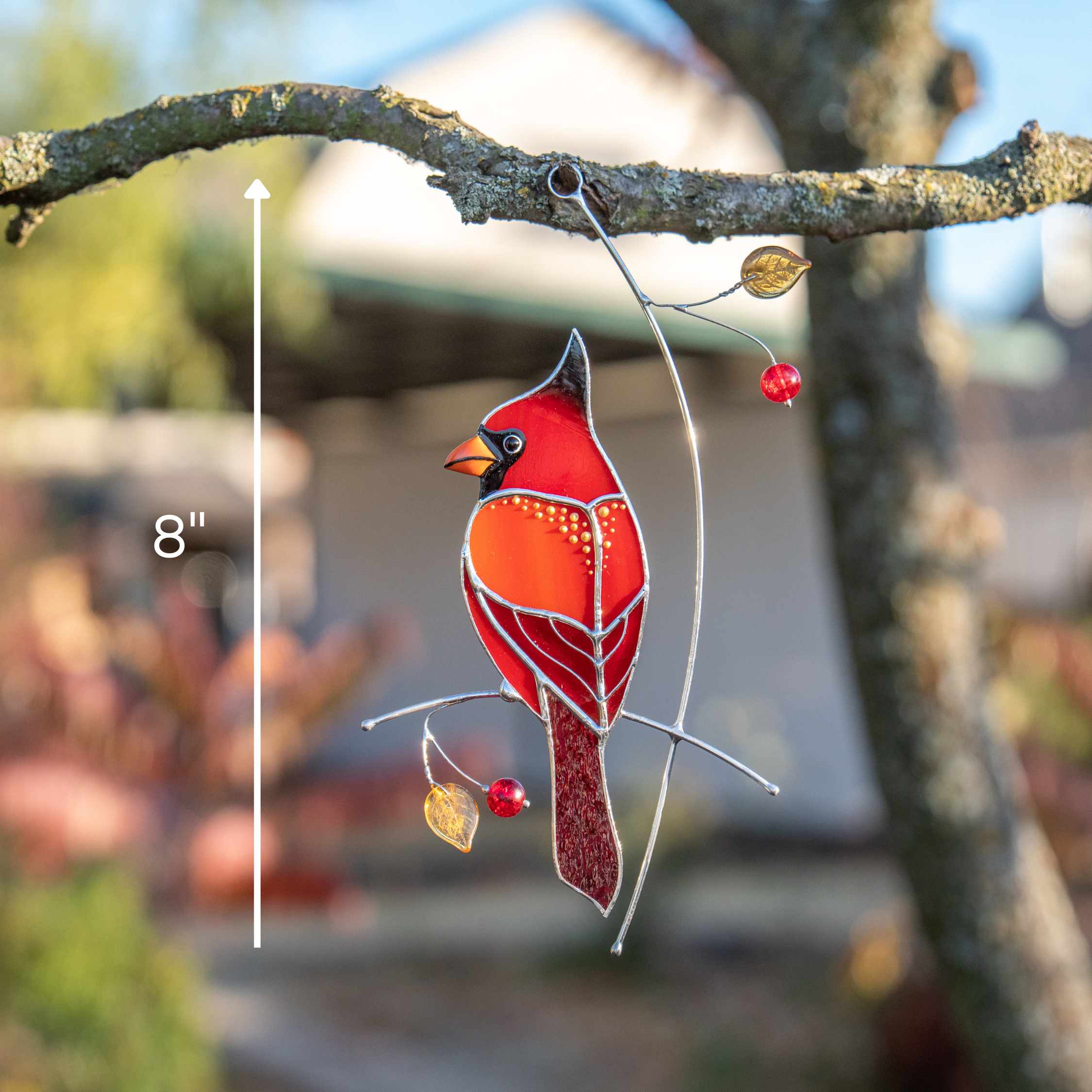 Cardinal suncatcher hanging outdoors — 8" tall, glowing in sunlight.