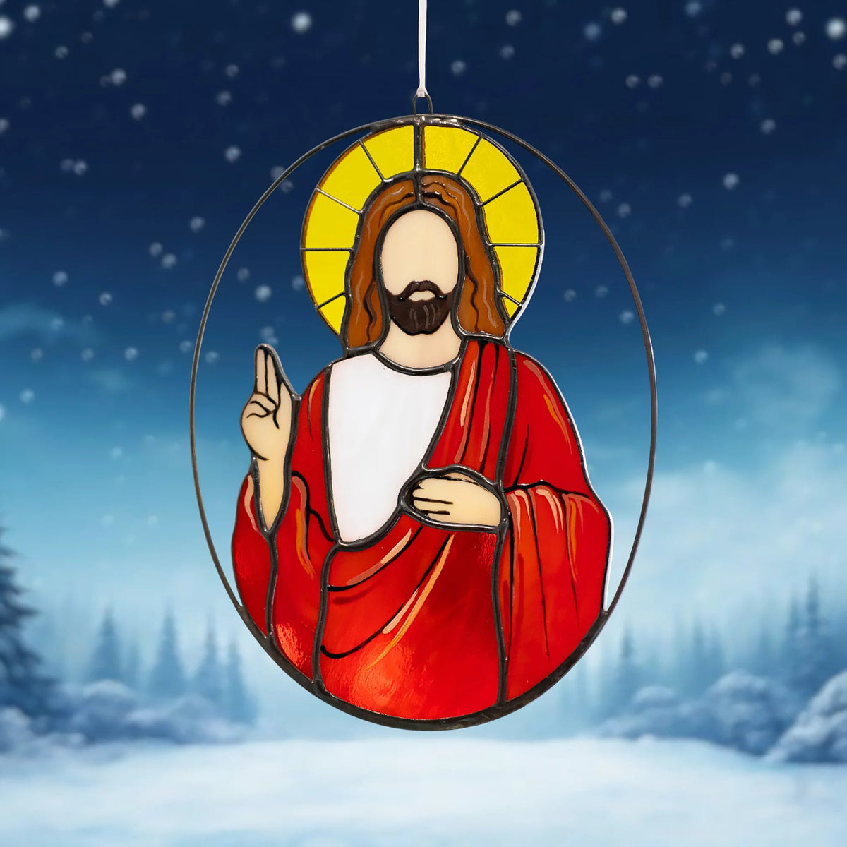 Jesus Christmas stained glass suncatcher hanging over a snowy night forest, its golden halo and red robe glowing against falling snow - handmade Christmas suncatcher and a heartfelt holiday gift