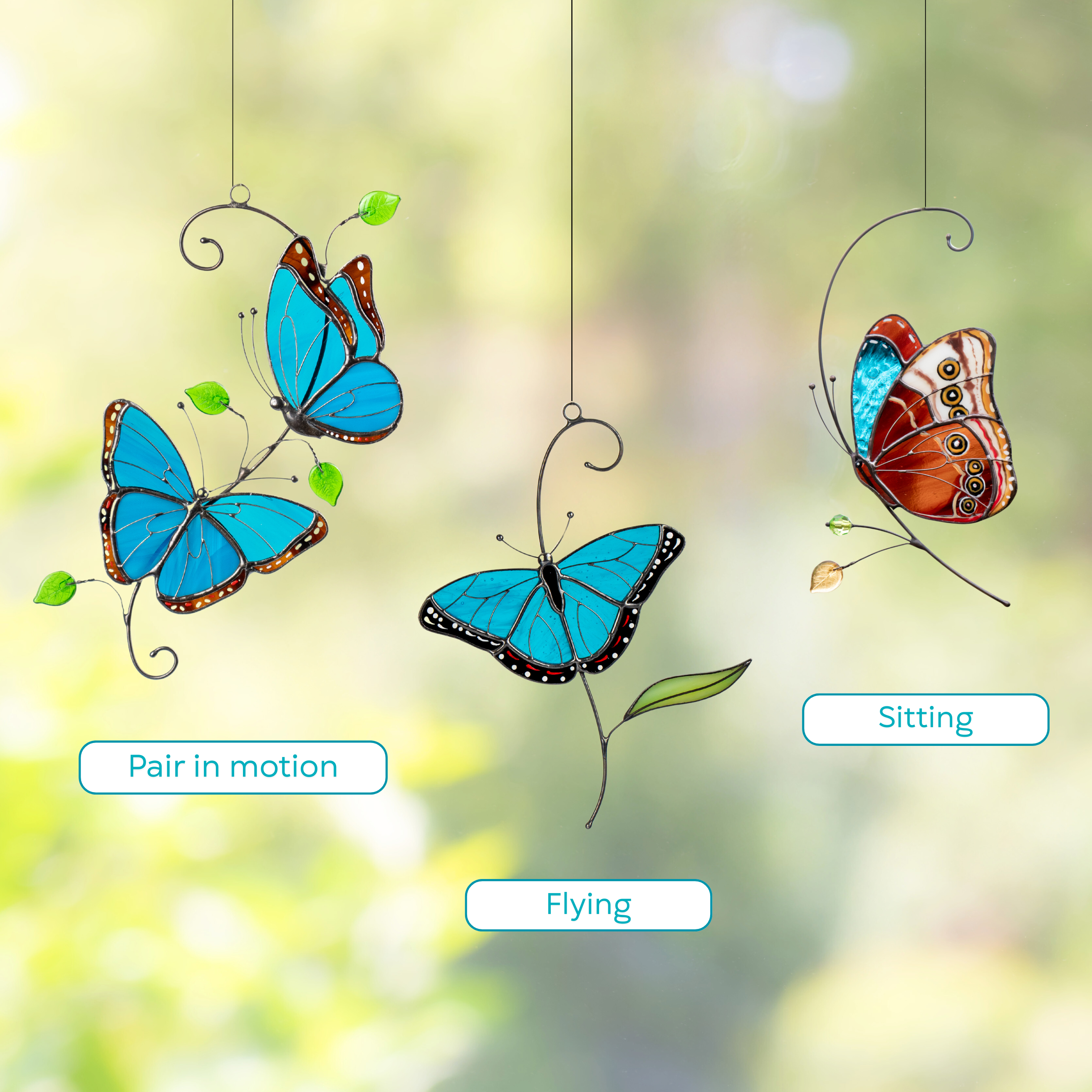 Three stained glass morpho butterflies are displayed against a blurred background: a pair with leaf details in motion, a single butterfly flying, and a side view sitting on the branch.
