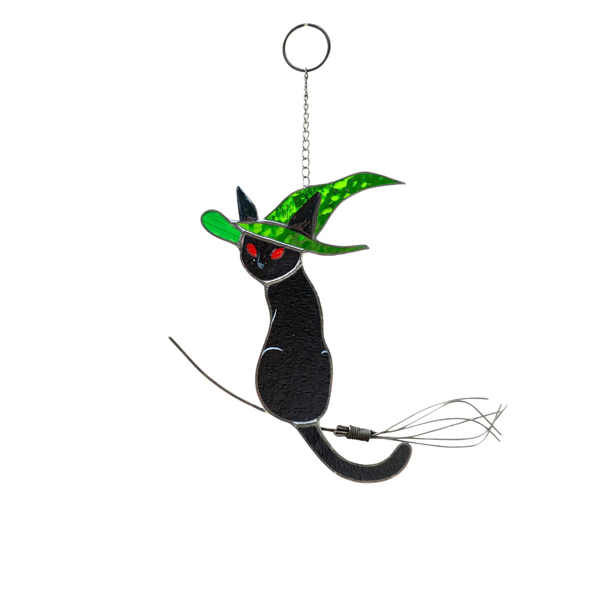 Stained glass black cat with green witch hat and red eyes suncatcher on a white background