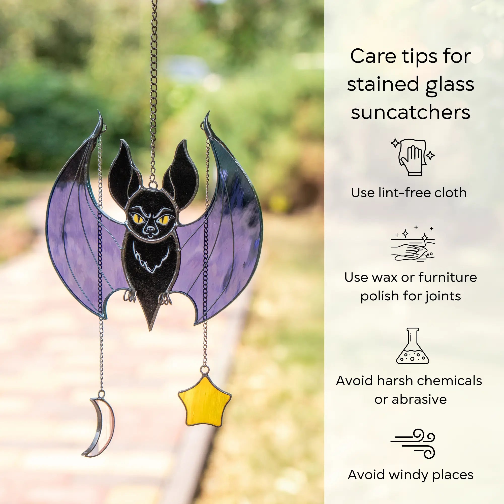 Stained glass suncatcher shaped like a bat with care tips on a blurred natural background: use lint-free cloth, polish joints with car wax or furniture polish, avoid harsh chemicals, and windy places.
