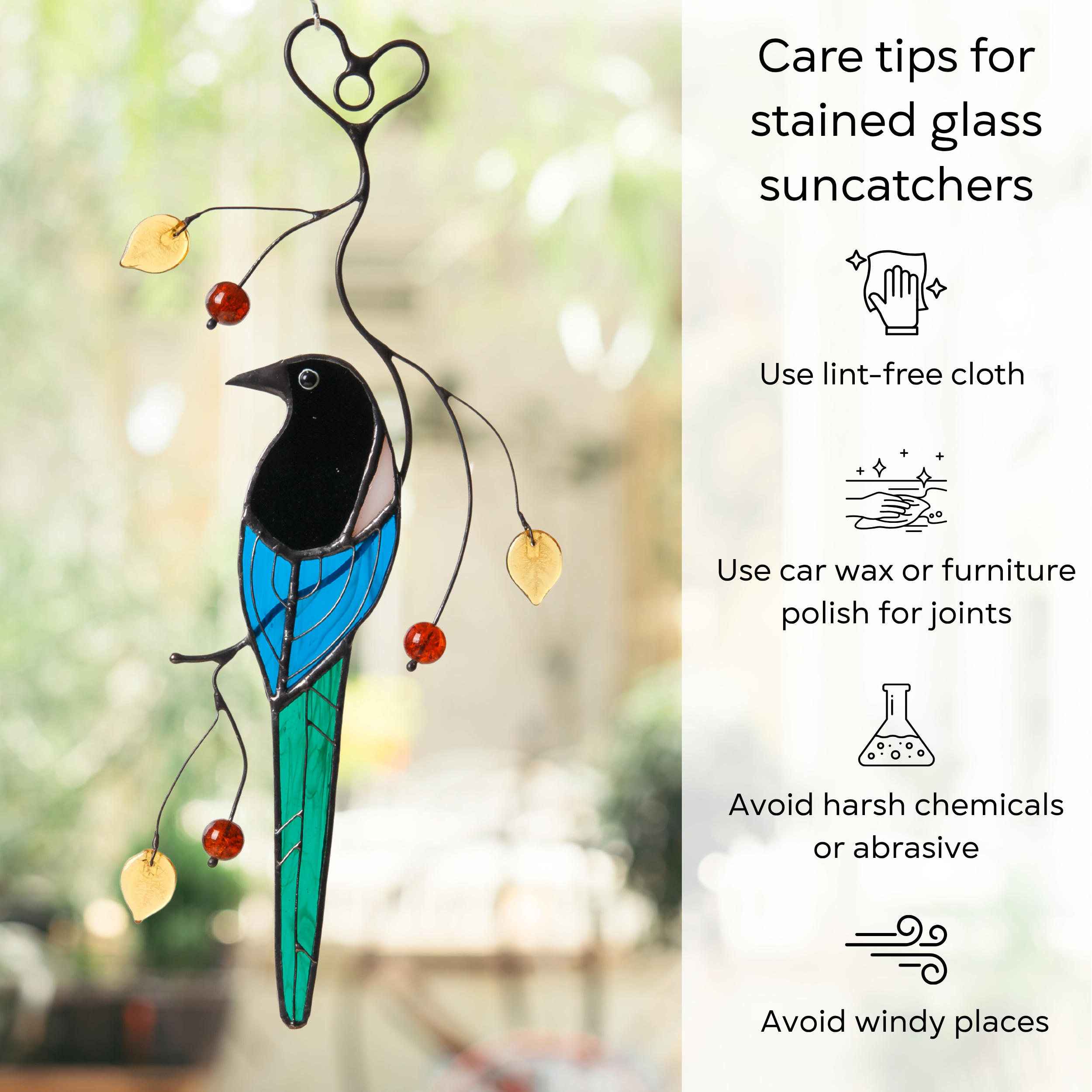 Stained glass magpie hanging with amber beads and care instructions displayed alongside: use lint-free cloth, use wax polish for joints, no harsh cleaners, avoid wind.