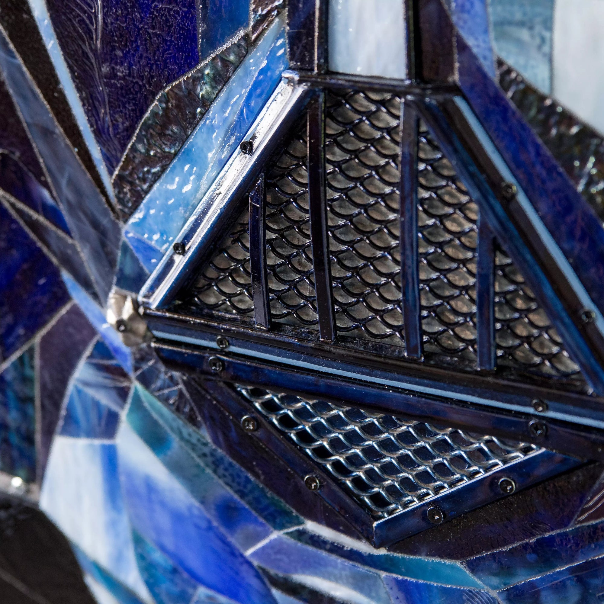 Detailed shot of the mouth section of the stained glass Darth Vader, highlighting layered textures.