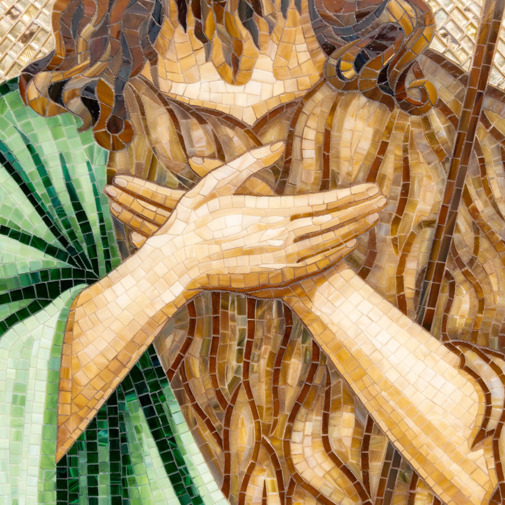 Mosaic detail showing Saint John the Baptist’s folded hands and robe textures