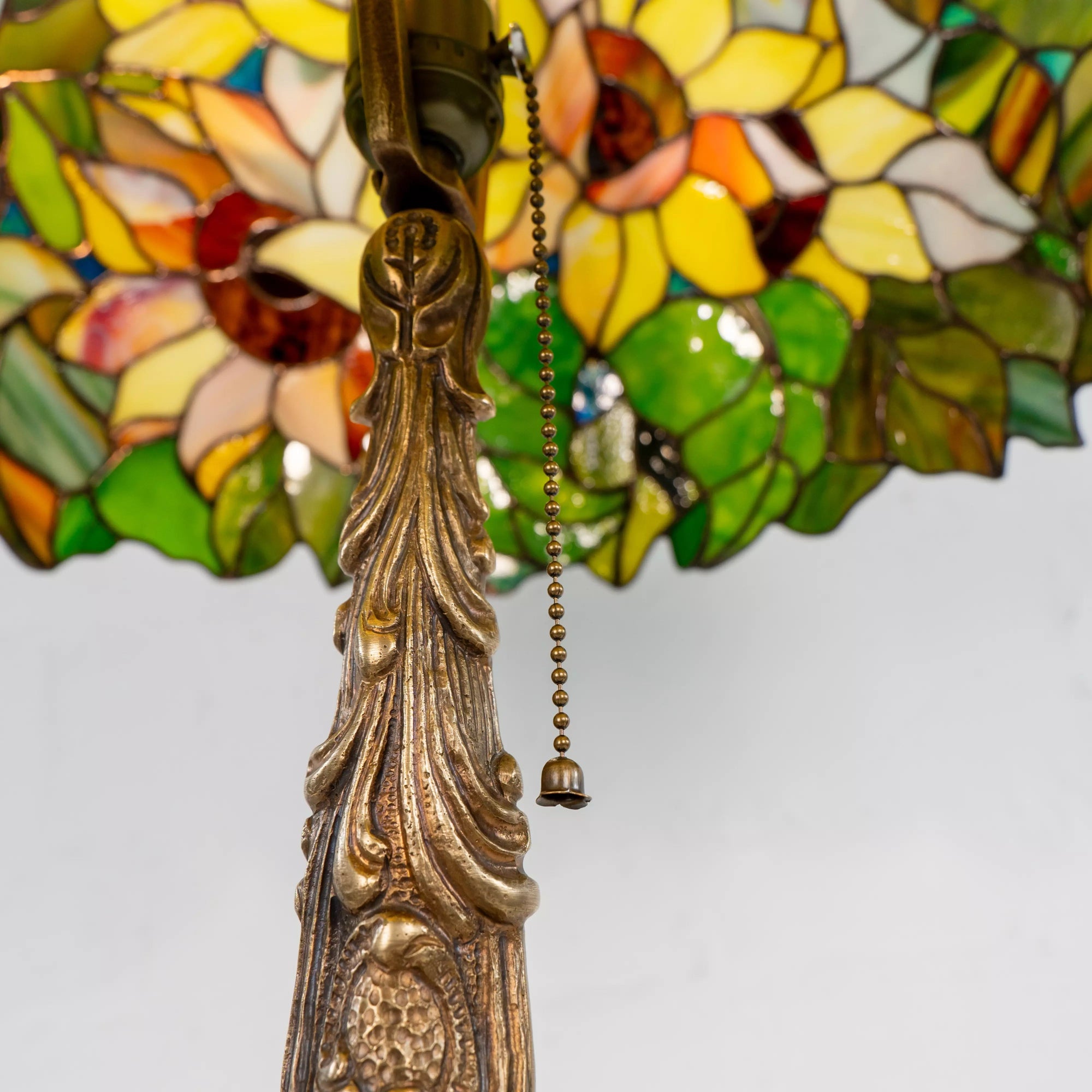 Detailed bronze lamp base with floral engraving and pull switch