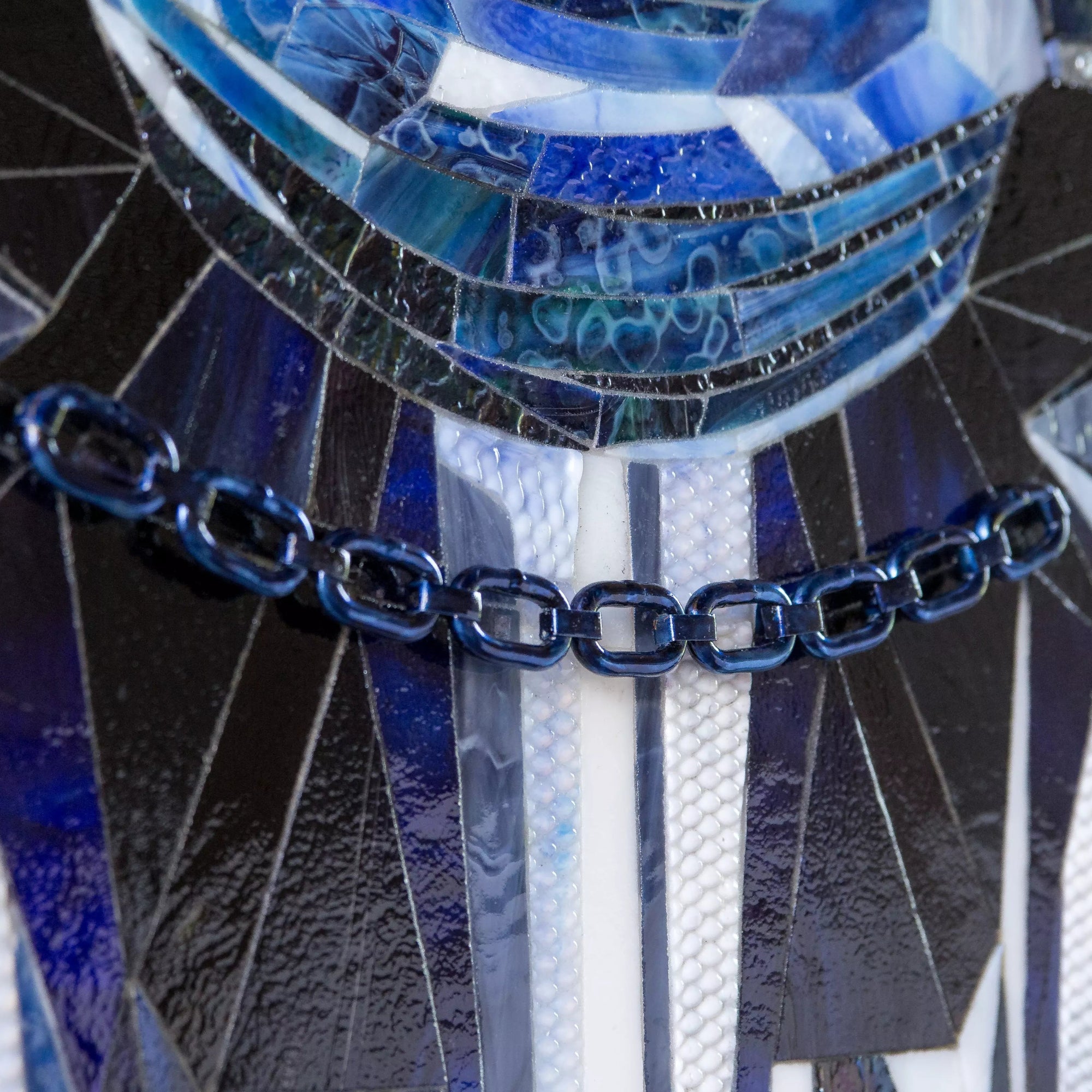 Zoom-in on the lower part of the mosaic showing blue glass chain and shoulder detail.