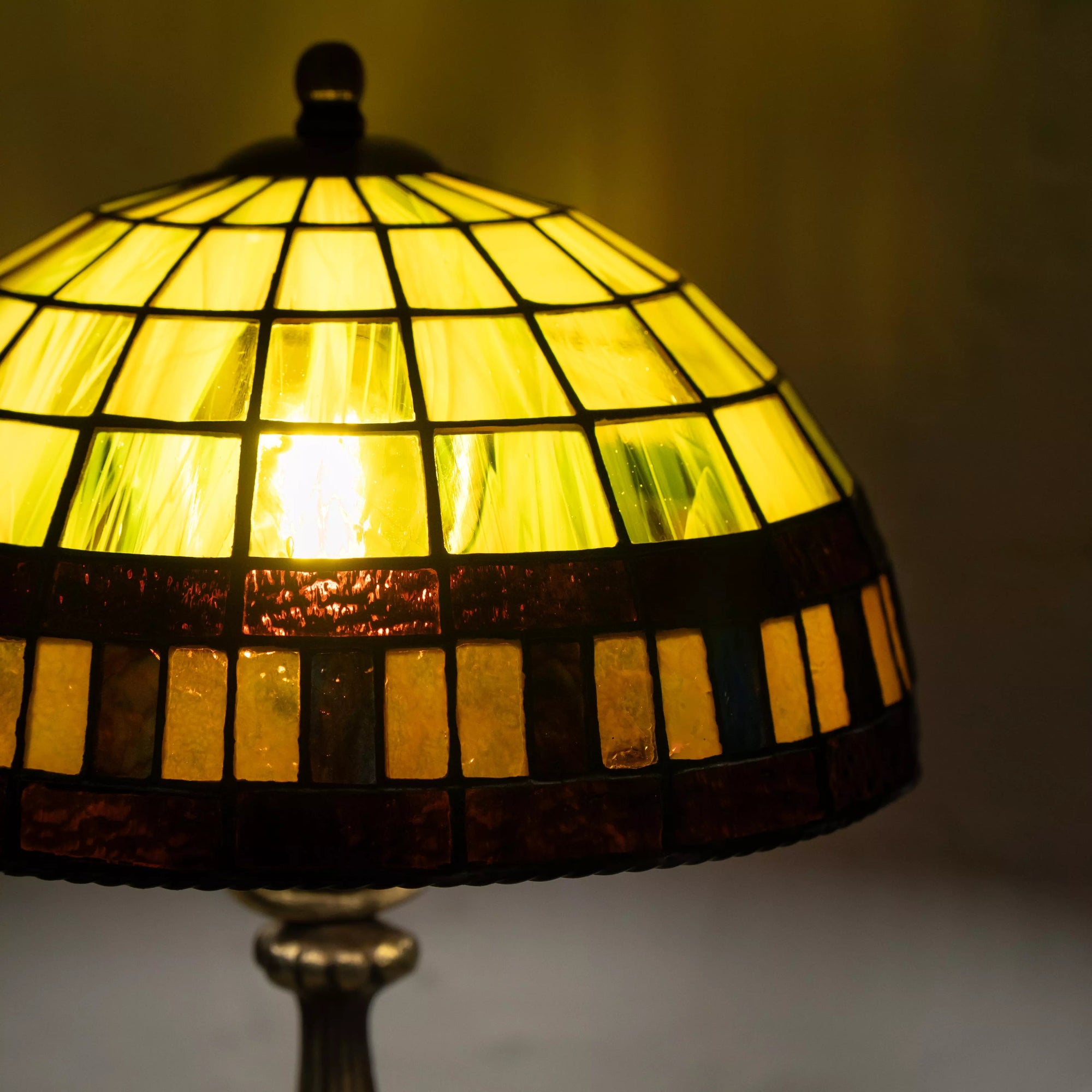 Bright stained glass dome in yellow and amber tones with light shining through glass tiles