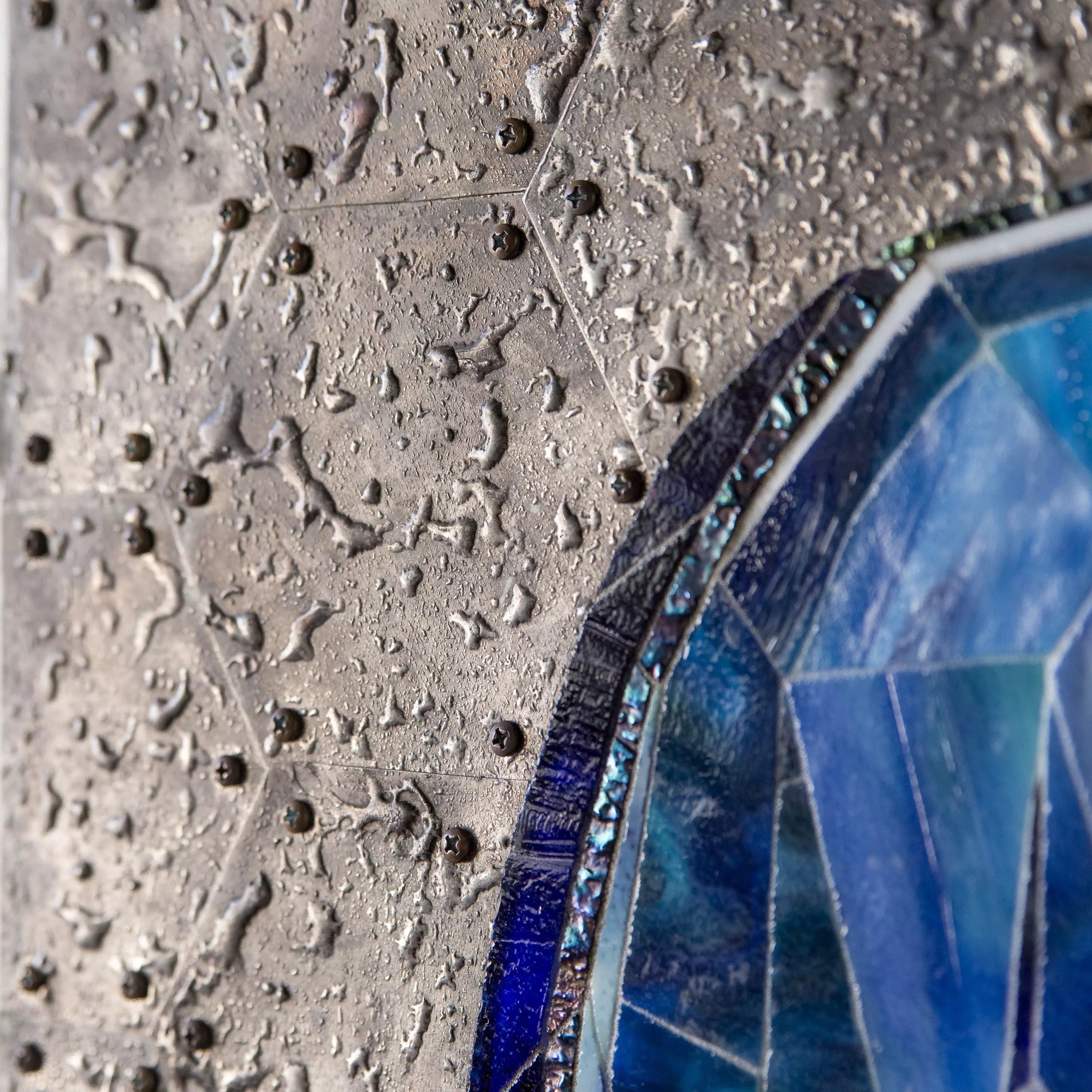 Detailed texture of the silver galactic background with hexagonal and rivet patterns.