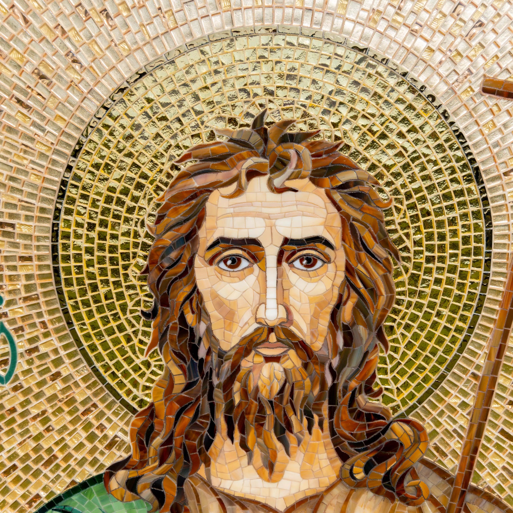 Face and golden halo of John the Baptist depicted in fine mosaic work