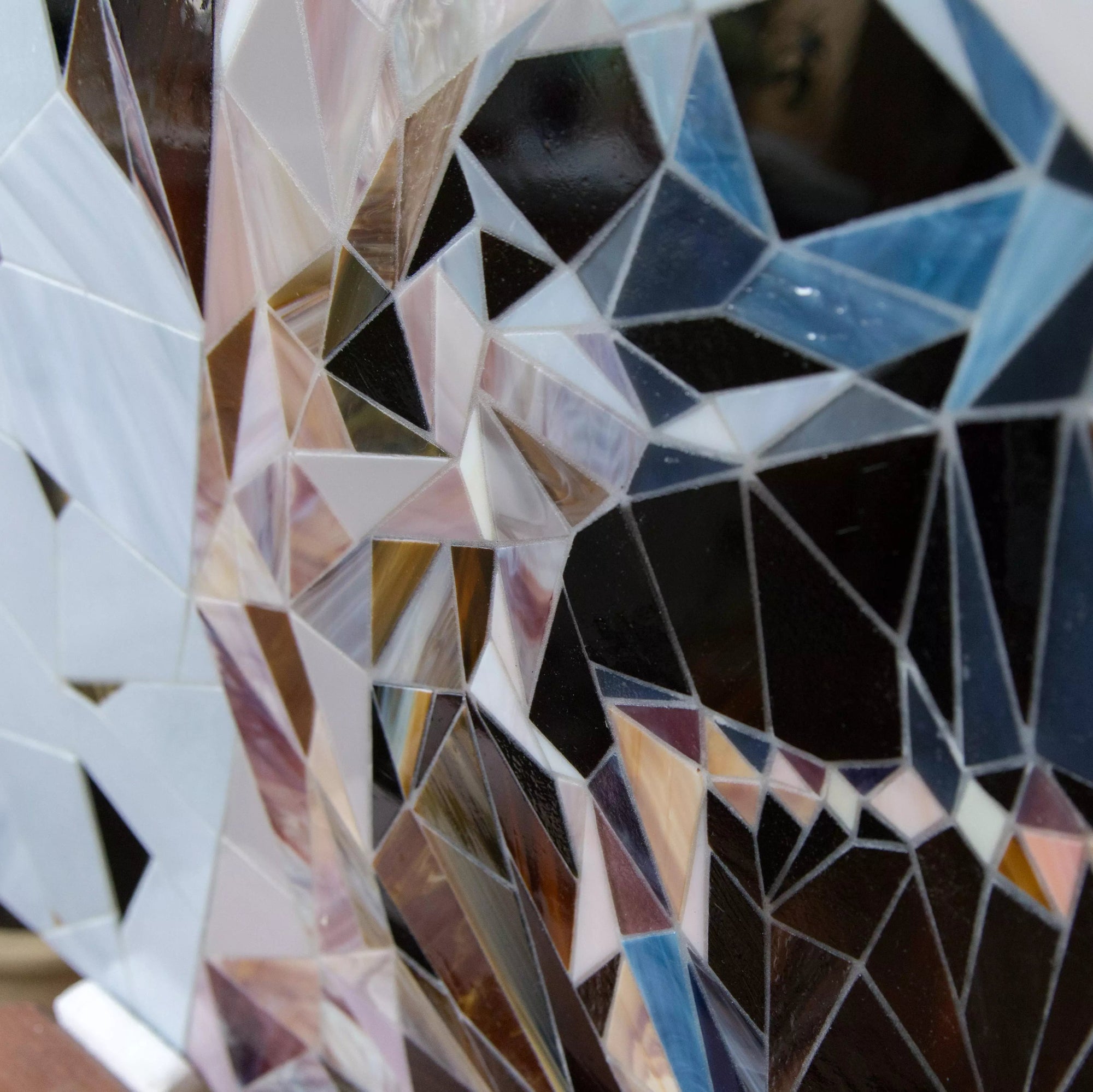 Detailed view of the bear’s mouth area in the geometric mosaic made of stained glass pieces