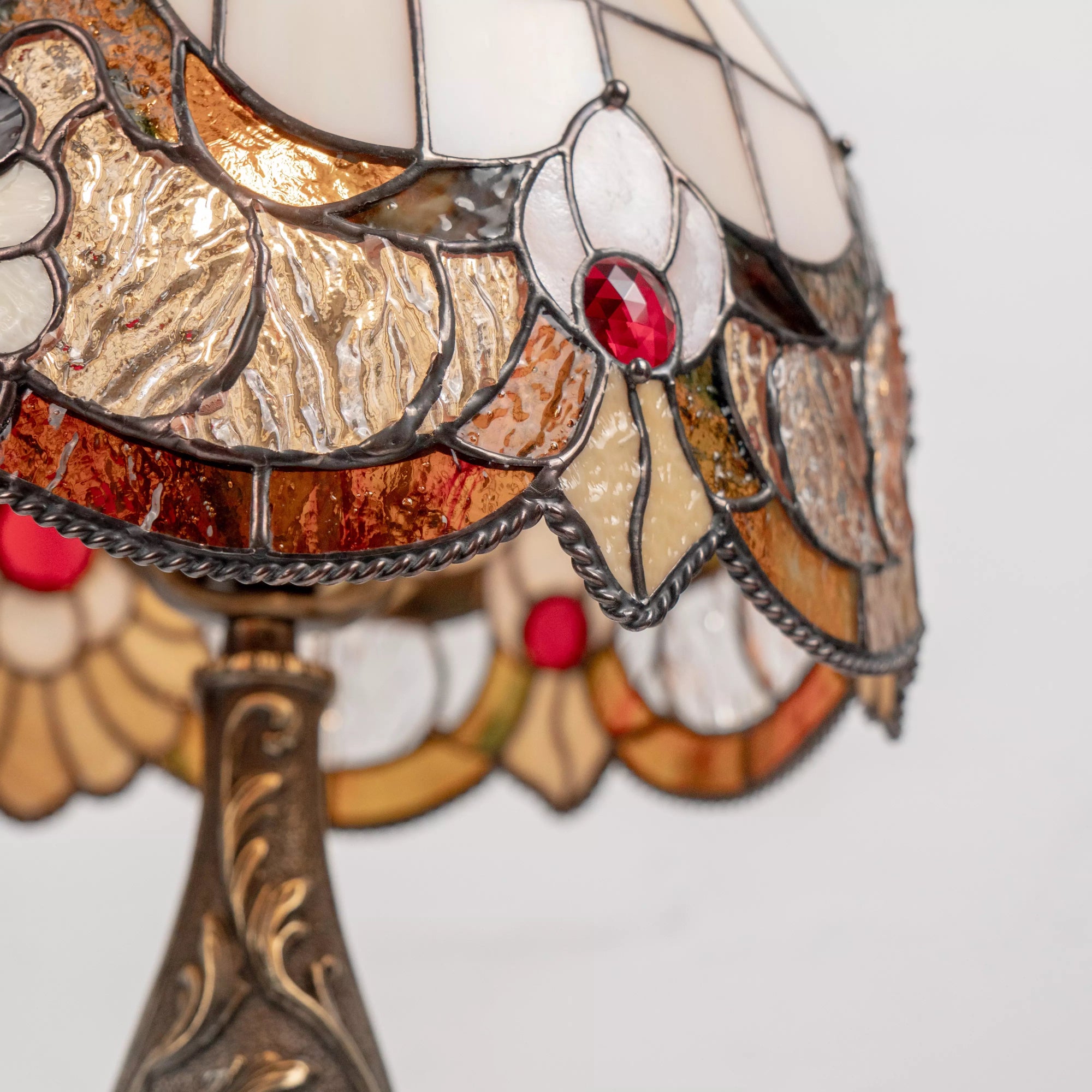 Stained glass pattern with red crystal in center and curved petal-like elements