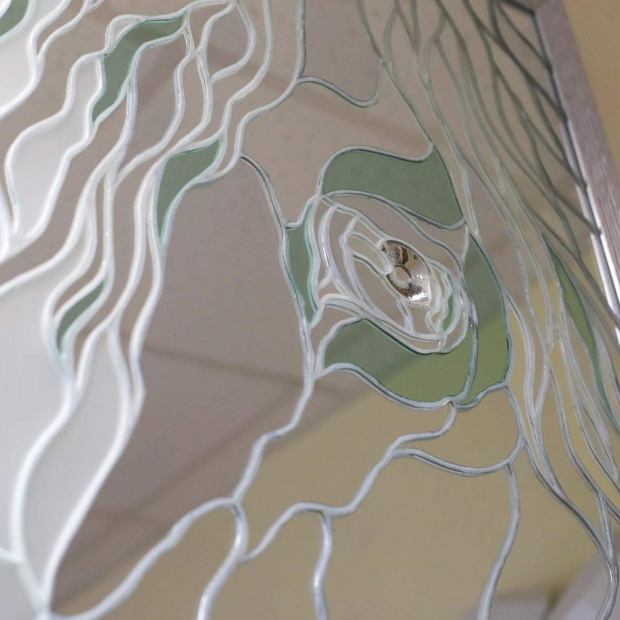 Macro view of a stained glass pattern depicting a horse eye with soft glass curves
