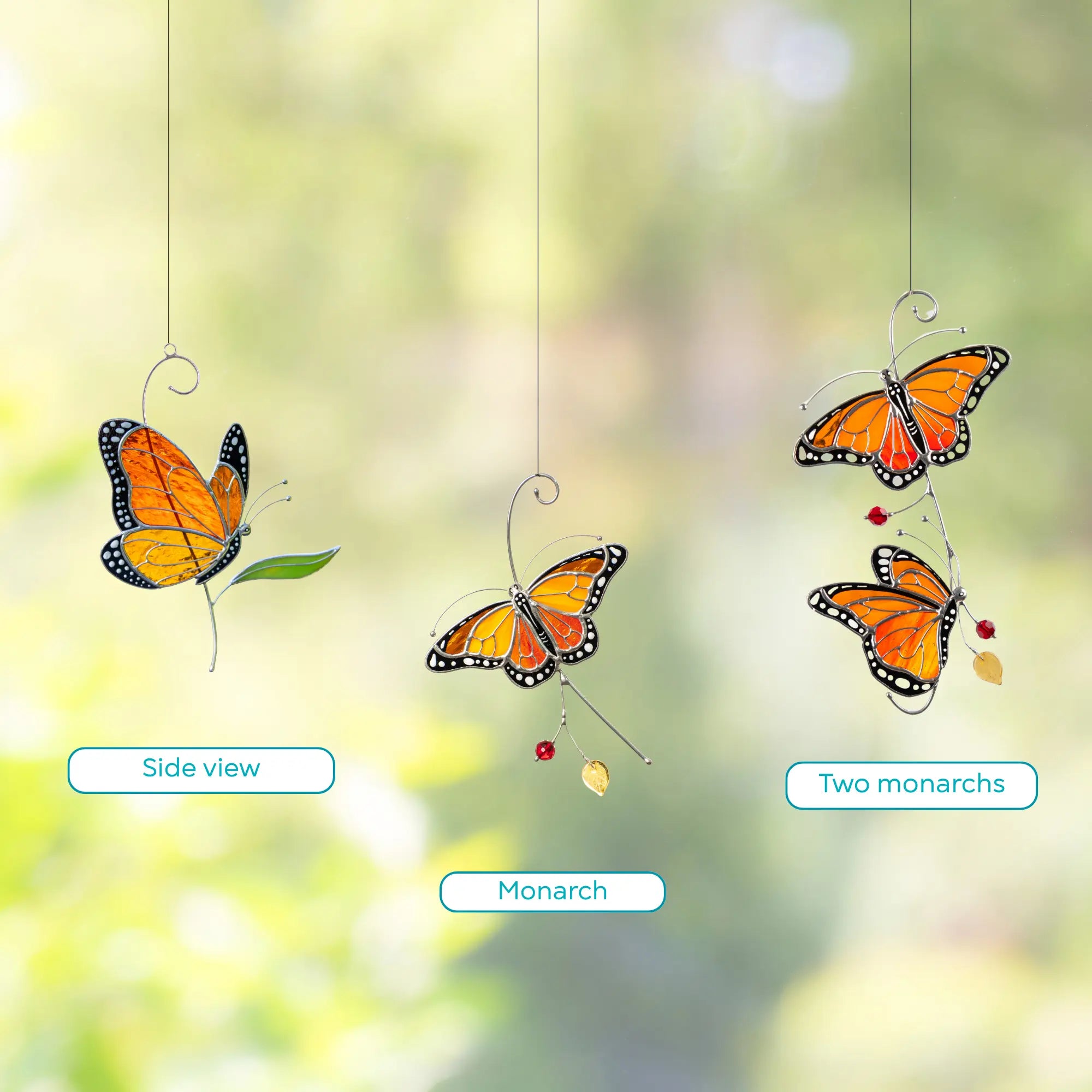 Stained glass 3 types of butterflies hanging against a blurred natural background