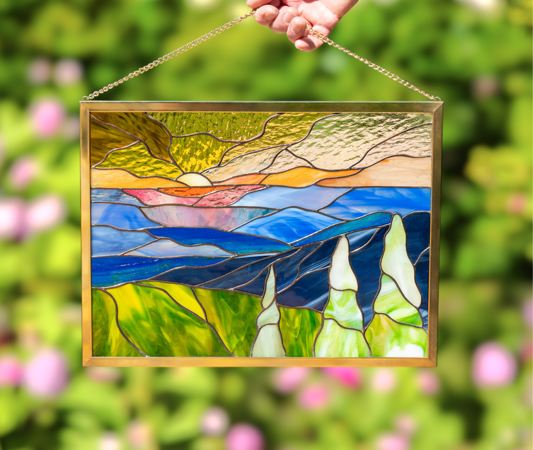 A hand holding stained glass decor