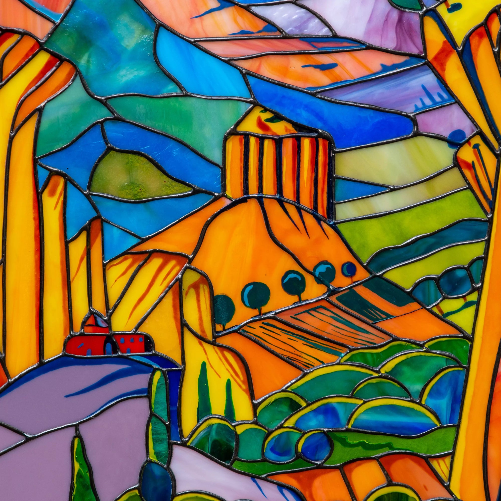 Colorful stained glass panel with landscape with mountains and houses