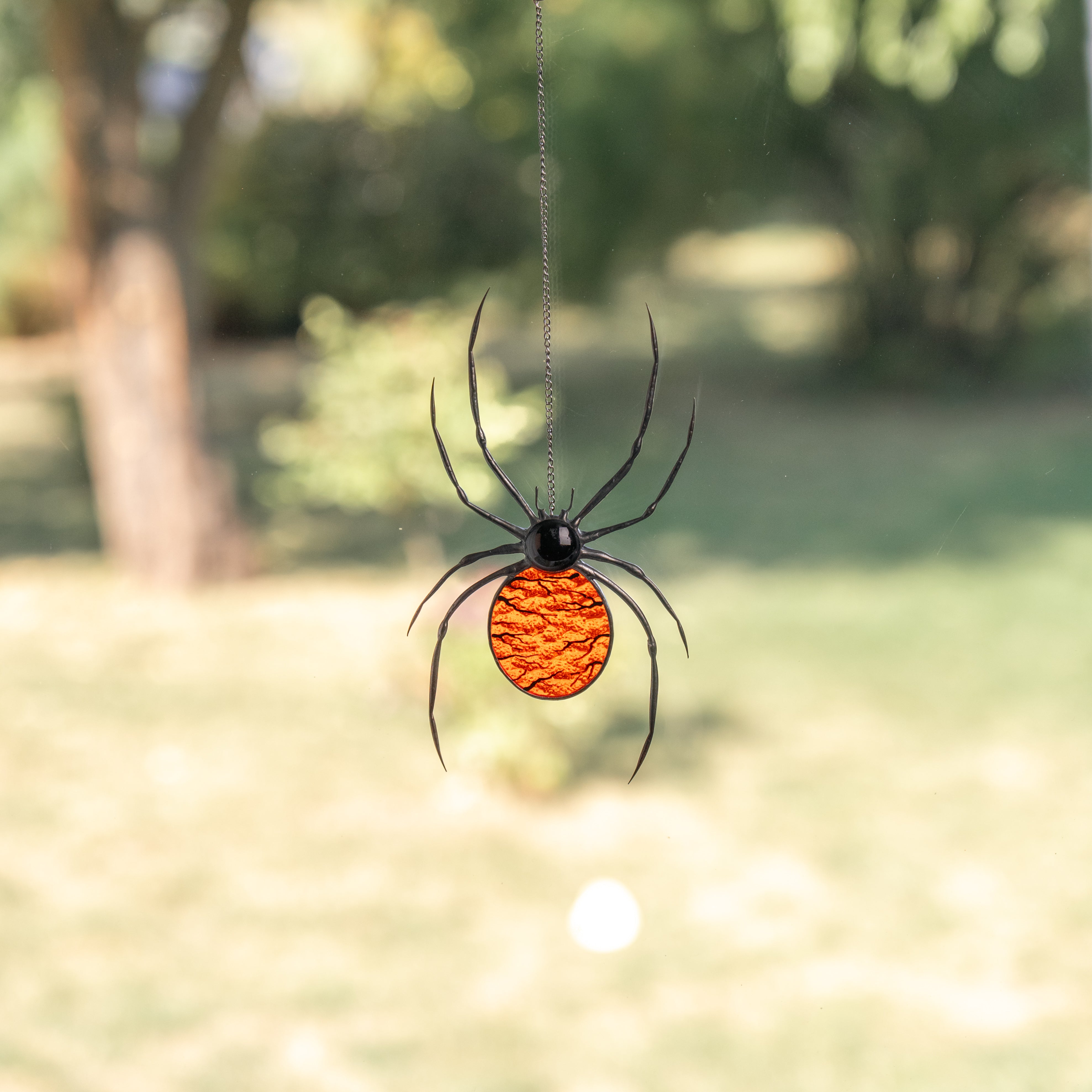orange body of the spider made of stained glass