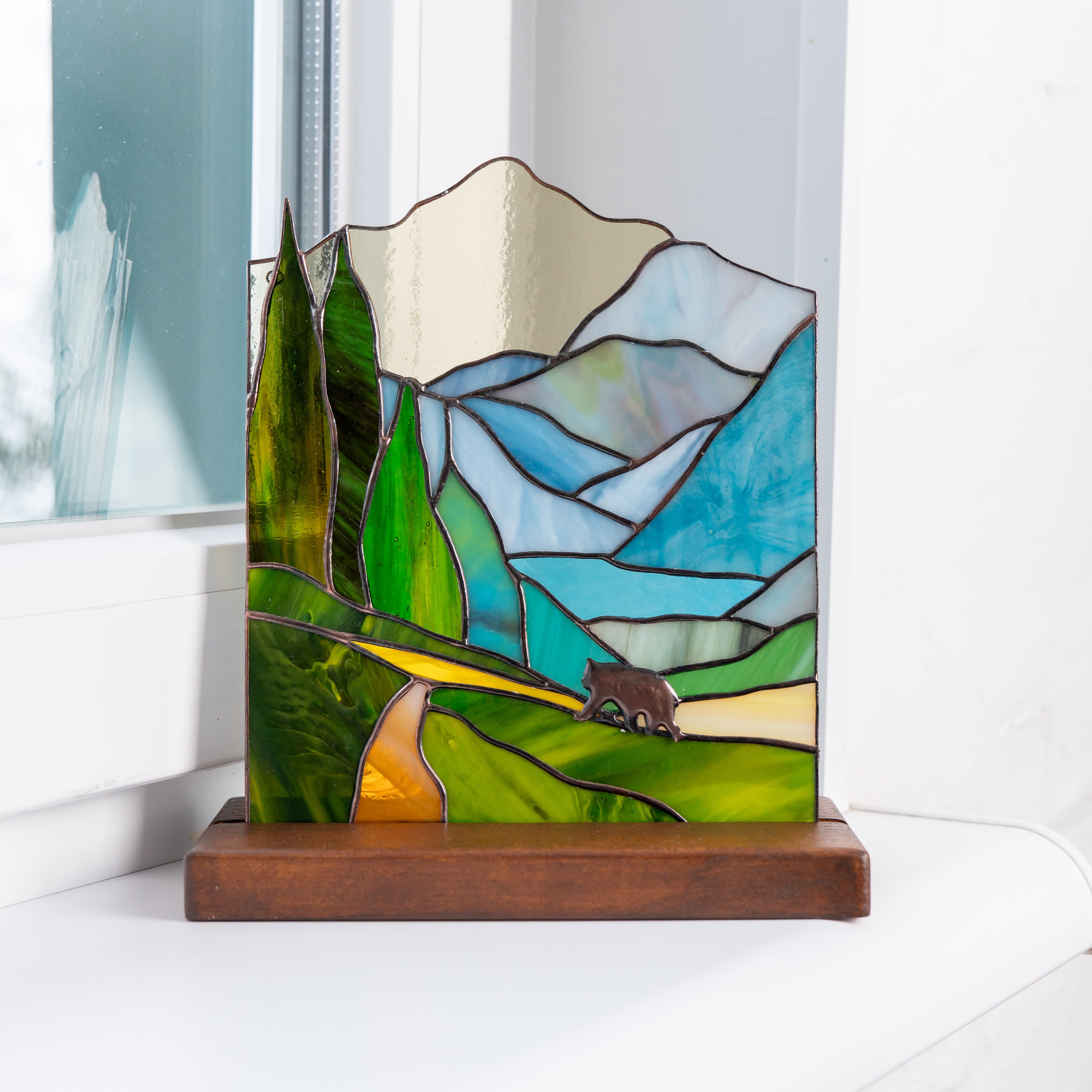 handcrafted glass panel of bear in the forest