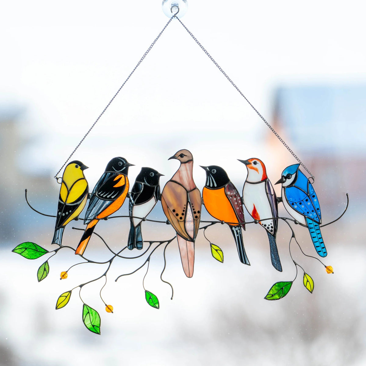 Stained glass suncatcher with seven birds sitting on a branch