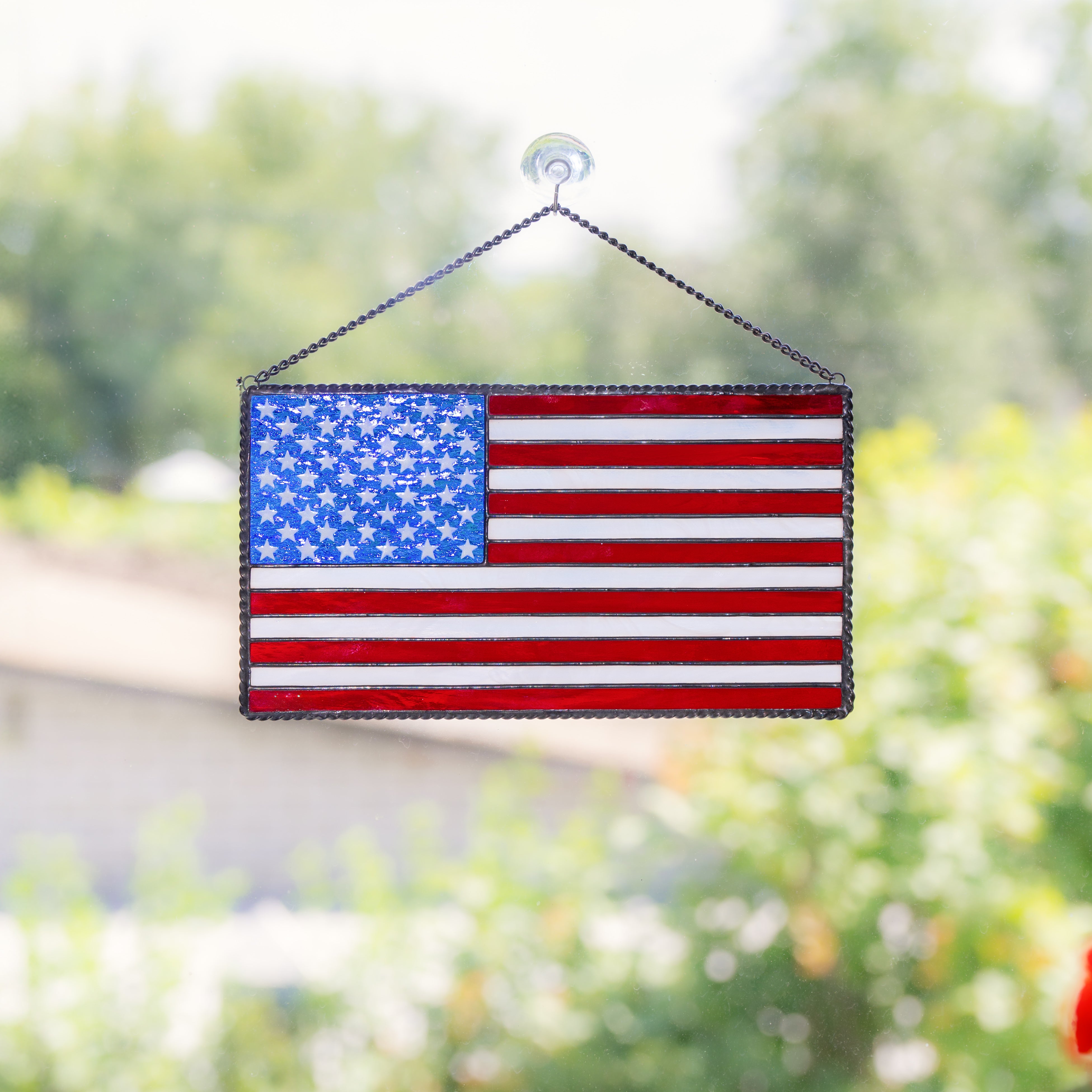 American flag made of modern stained glass is hanging on the window