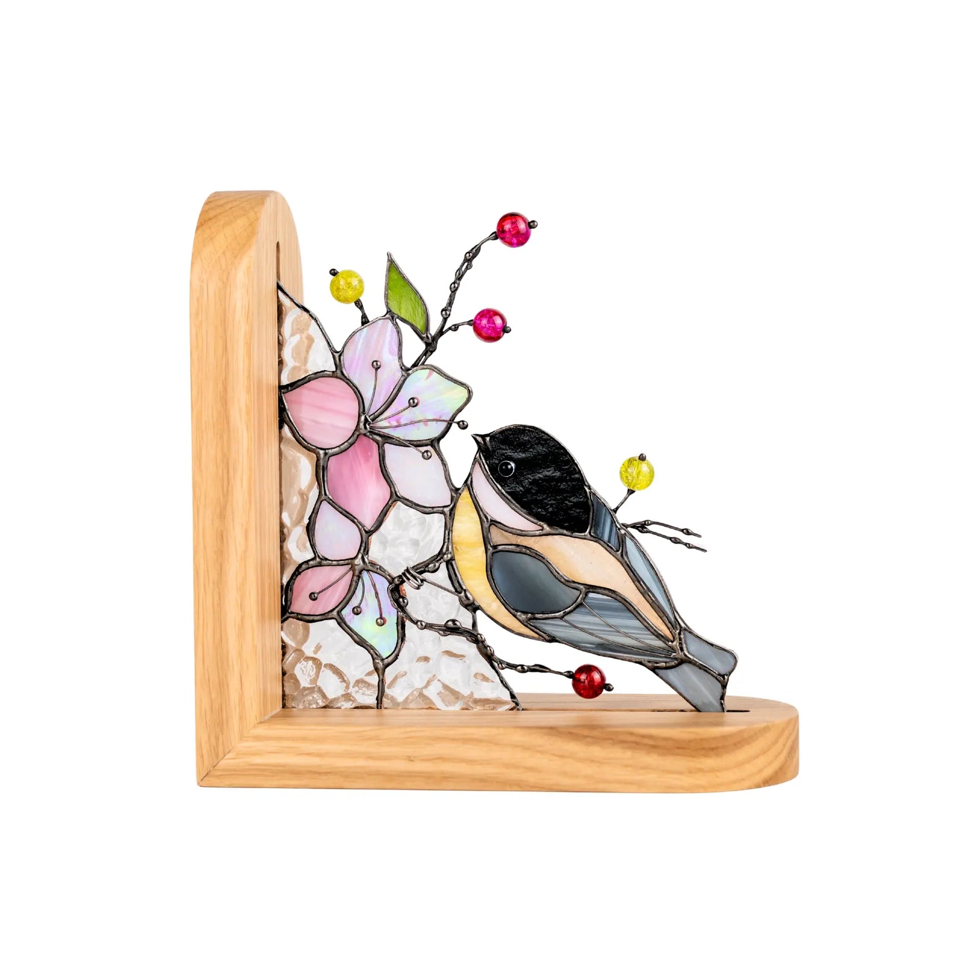 Stained glass bookend design of a chickadee and sakura flowers on a wooden base.