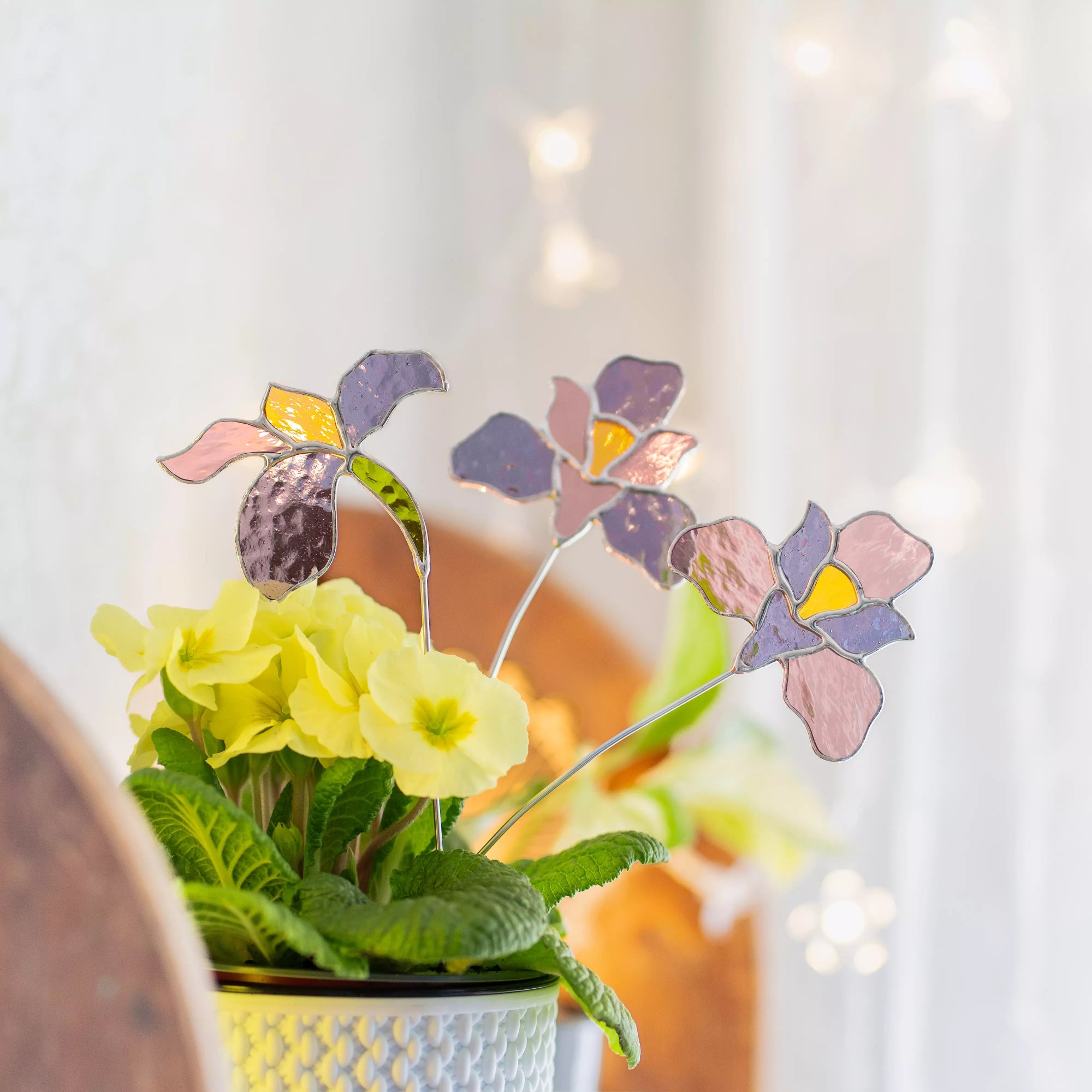 Stained glass iris flowers in a pot with a blurred background