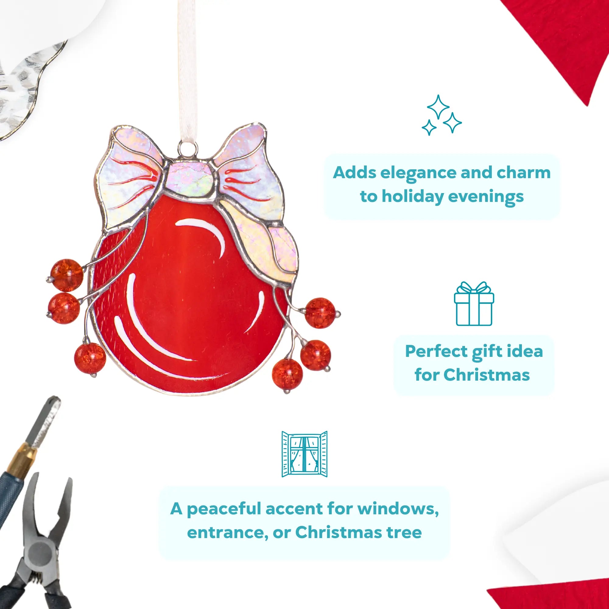 Stained glass ornament with red and iridescent glass, hanging on a string.