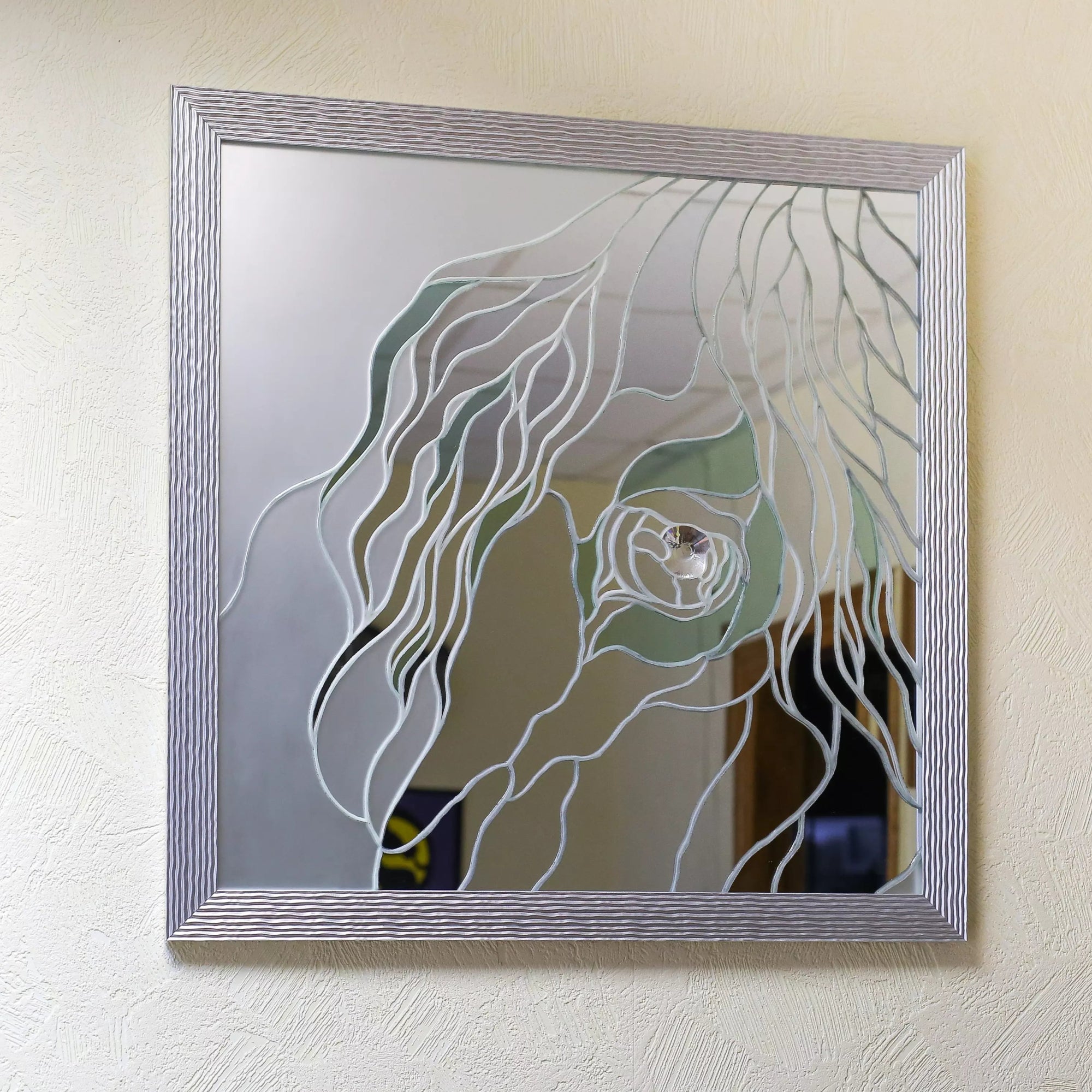 Wall-mounted mirror showing a stylized stained glass horse eye design with silver outline