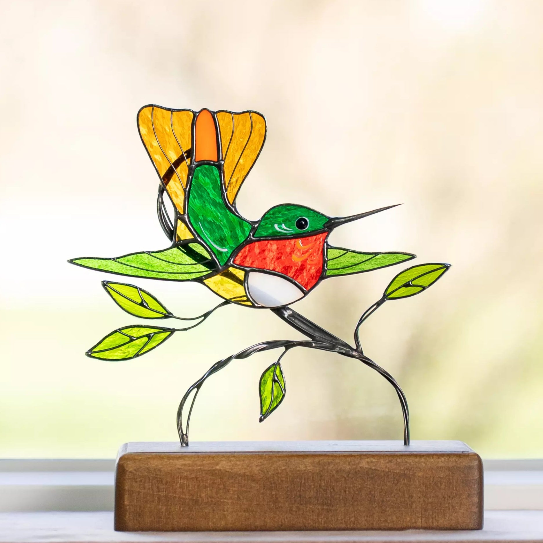Close-up of Decorative stained glass hummingbird on a stand with a blurred background
