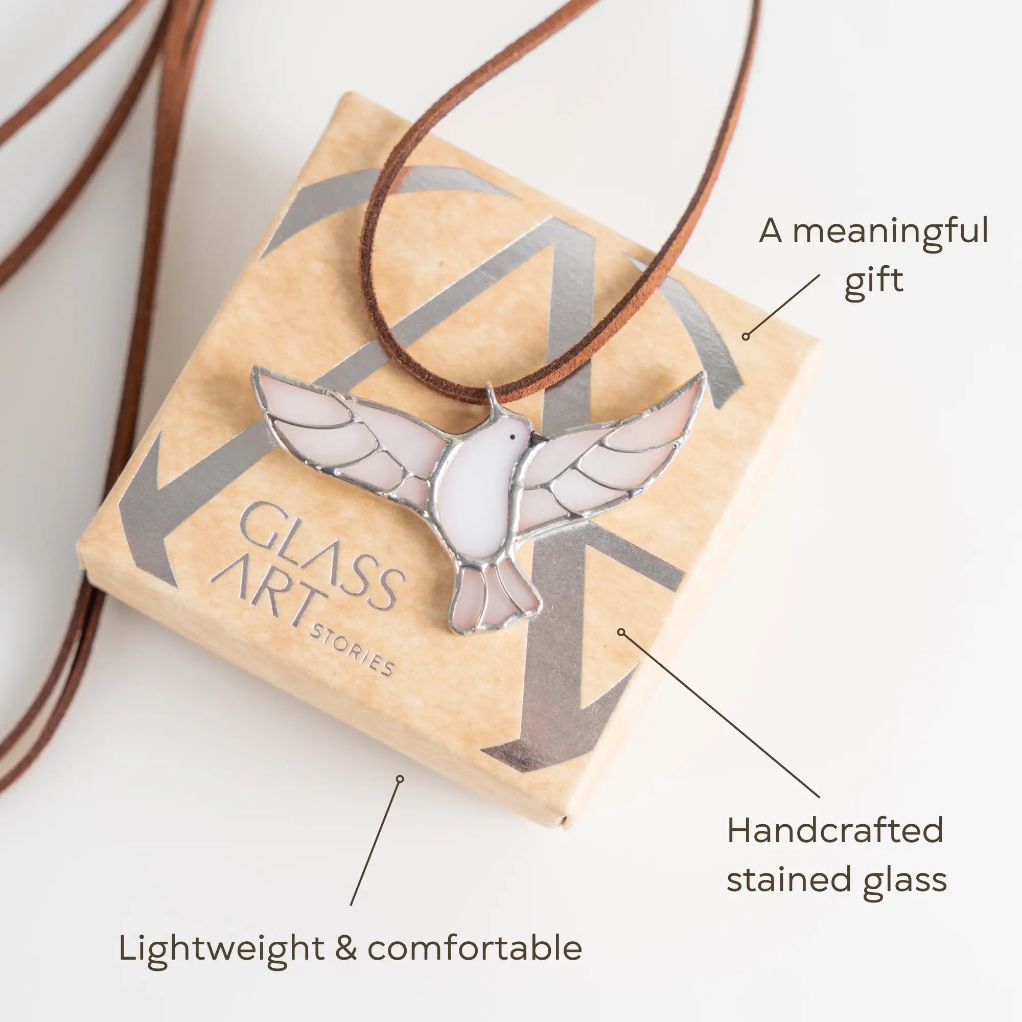 Stained glass dove pendant in gift box with brown cord, labeled lightweight and gift-ready
