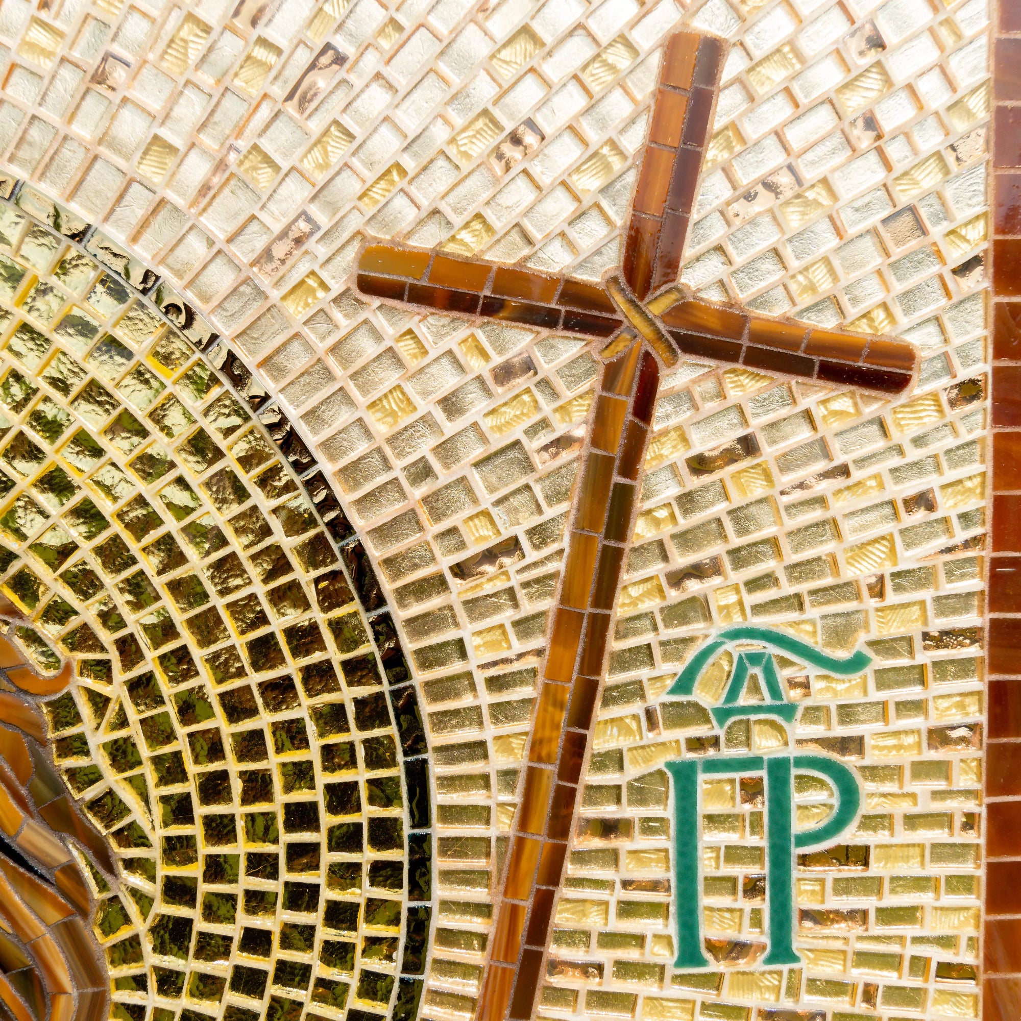Mosaic cross with intricate background and green Byzantine letters on right side