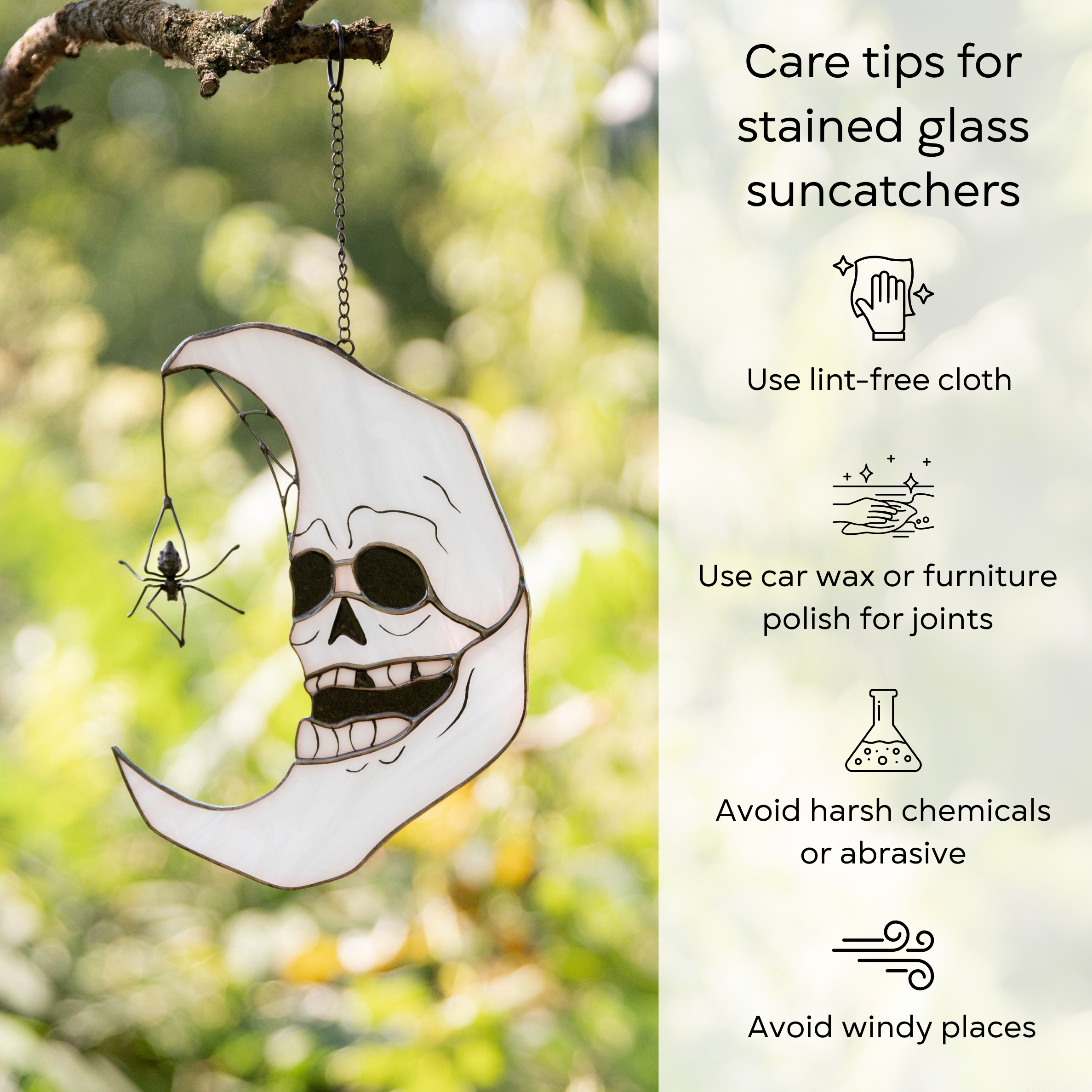 Stained glass skull moon hanging on a branch with care tips: use lint-free cloth, car wax for joints, avoid harsh chemicals and windy places.