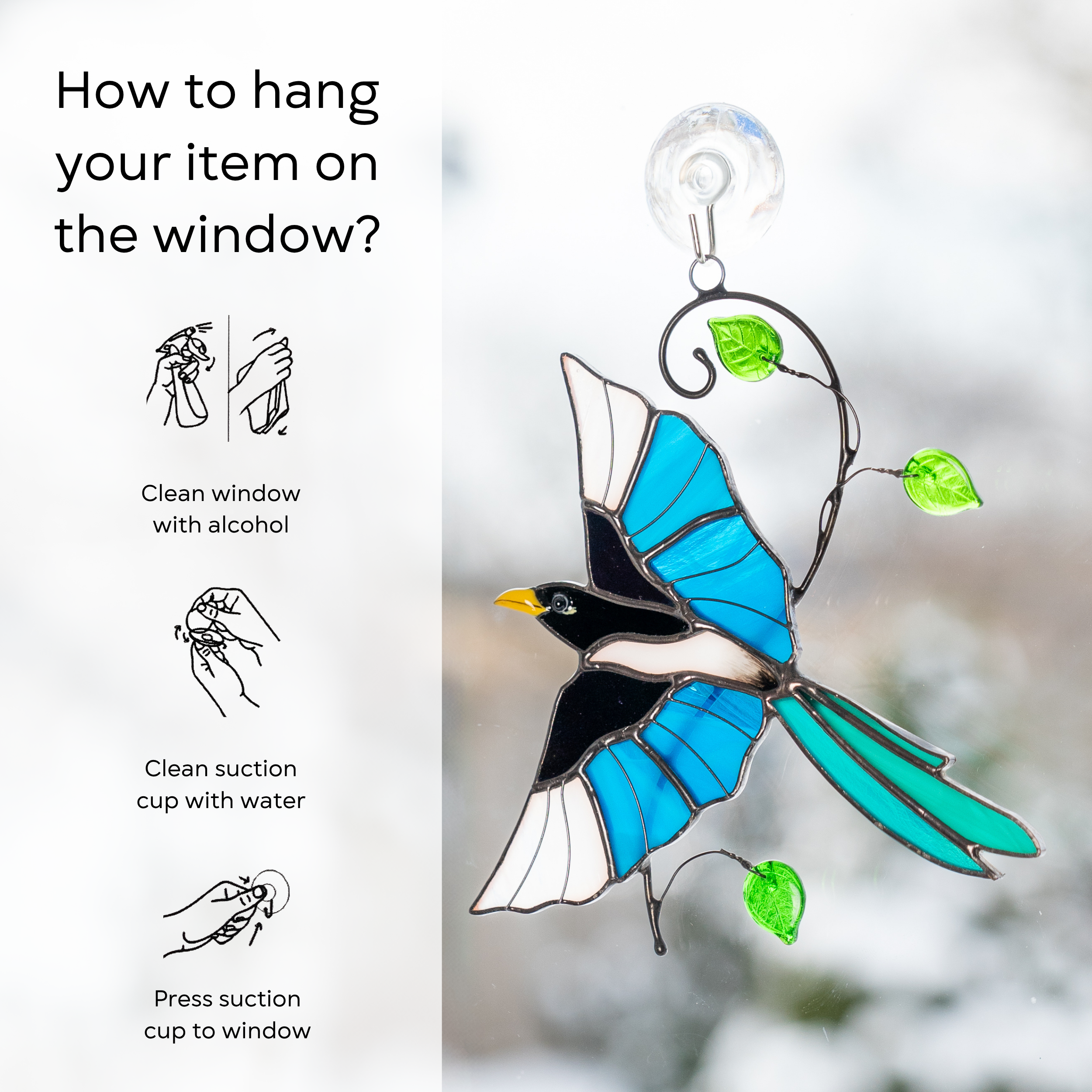 Vibrant stained glass magpie with yellow beak and blue wings, instruction on hanging a suction cup: clean window and suction cup, press a cup to the surface.