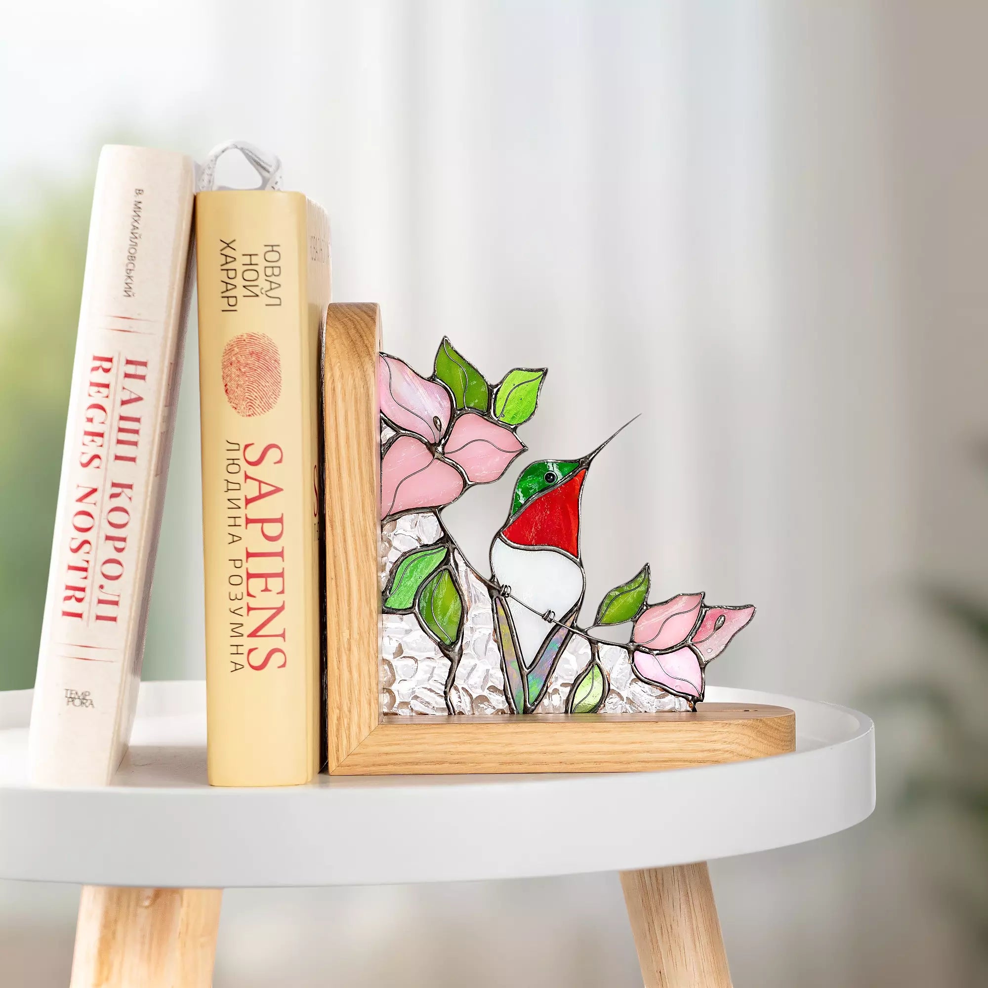 Hummingbird stained glass bookend holding books upright, perfect as a gift for book lovers.