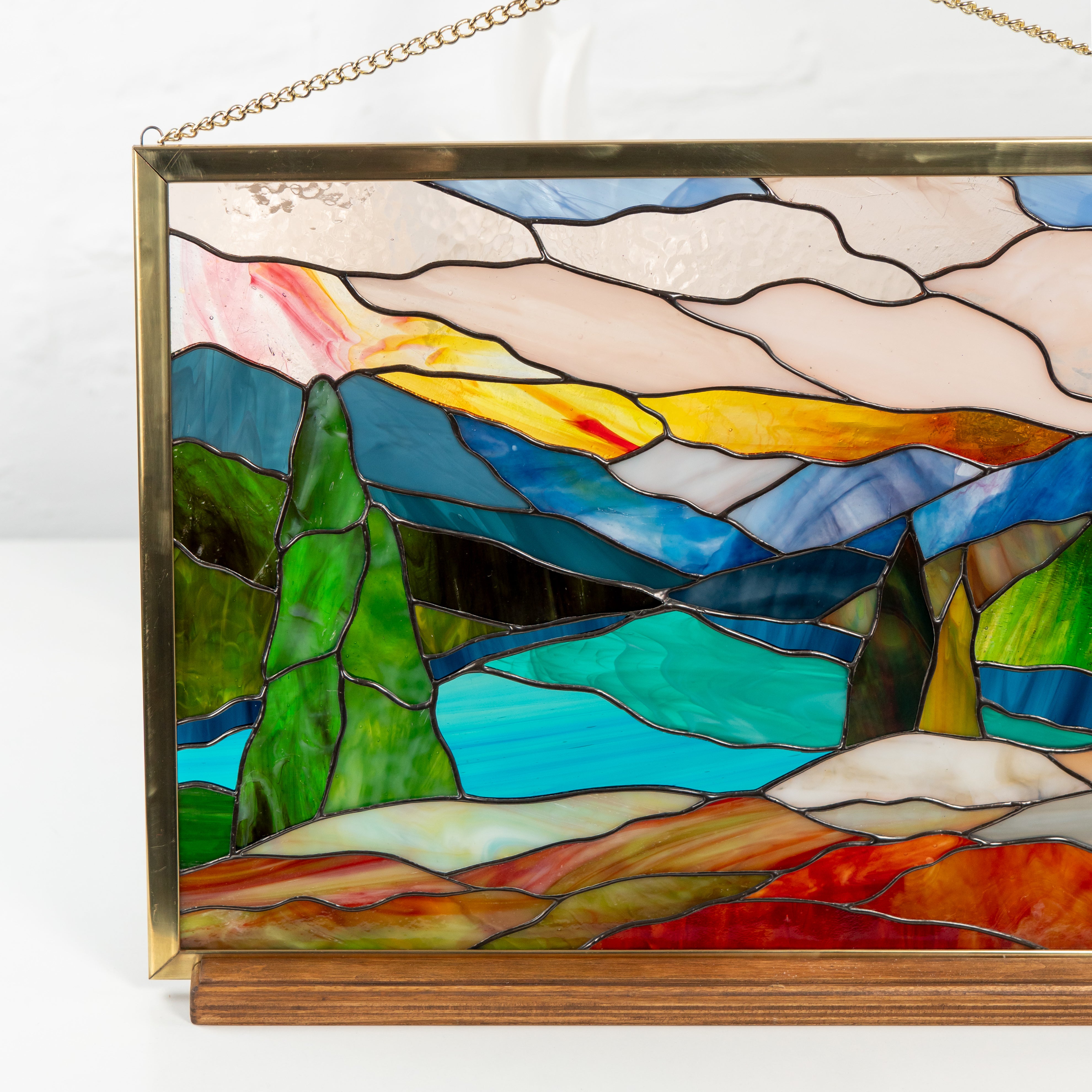 Mount Rainier stained glass art on wooden base, indoor setup