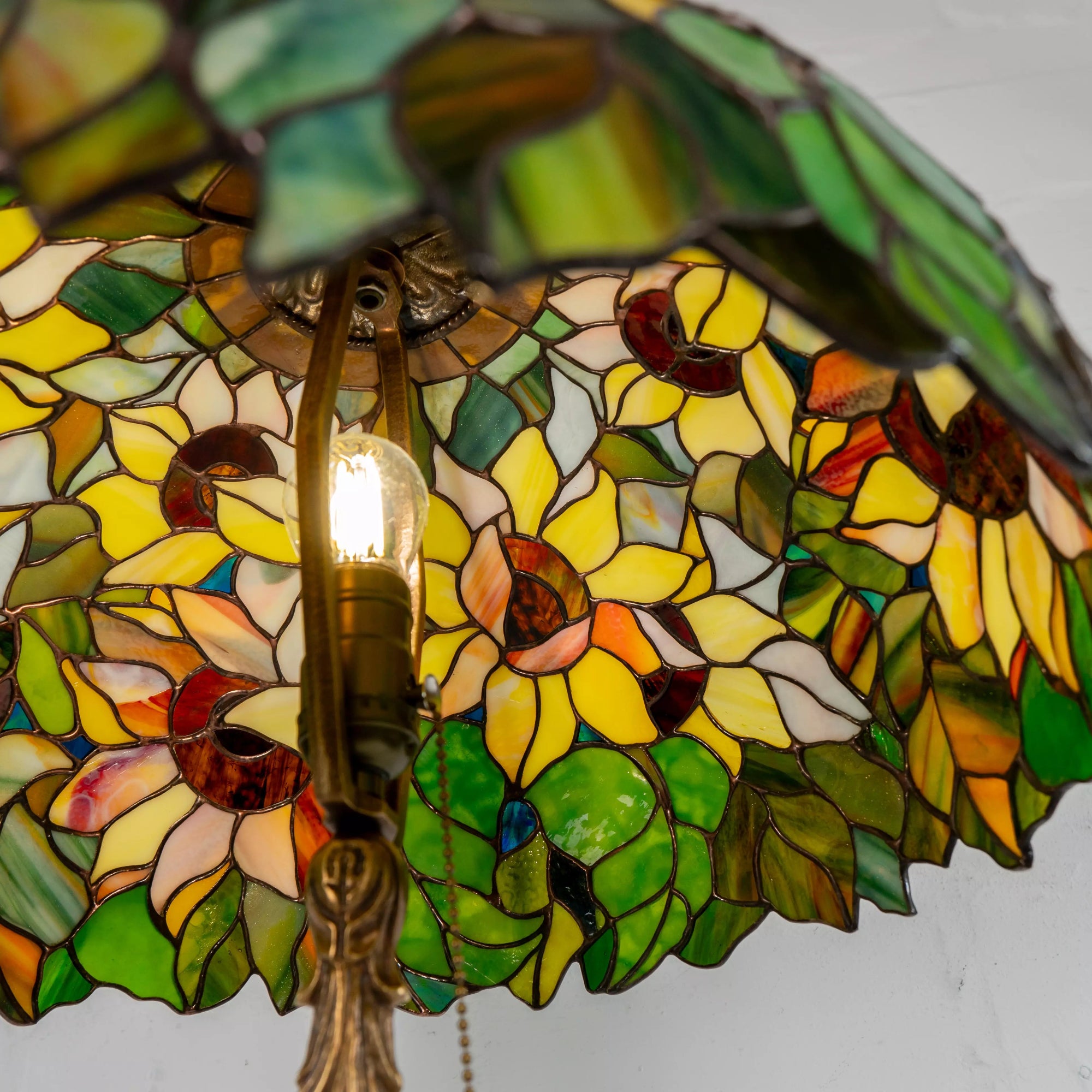 Looking inside the sunflower stained glass lamp with bulb and support rods