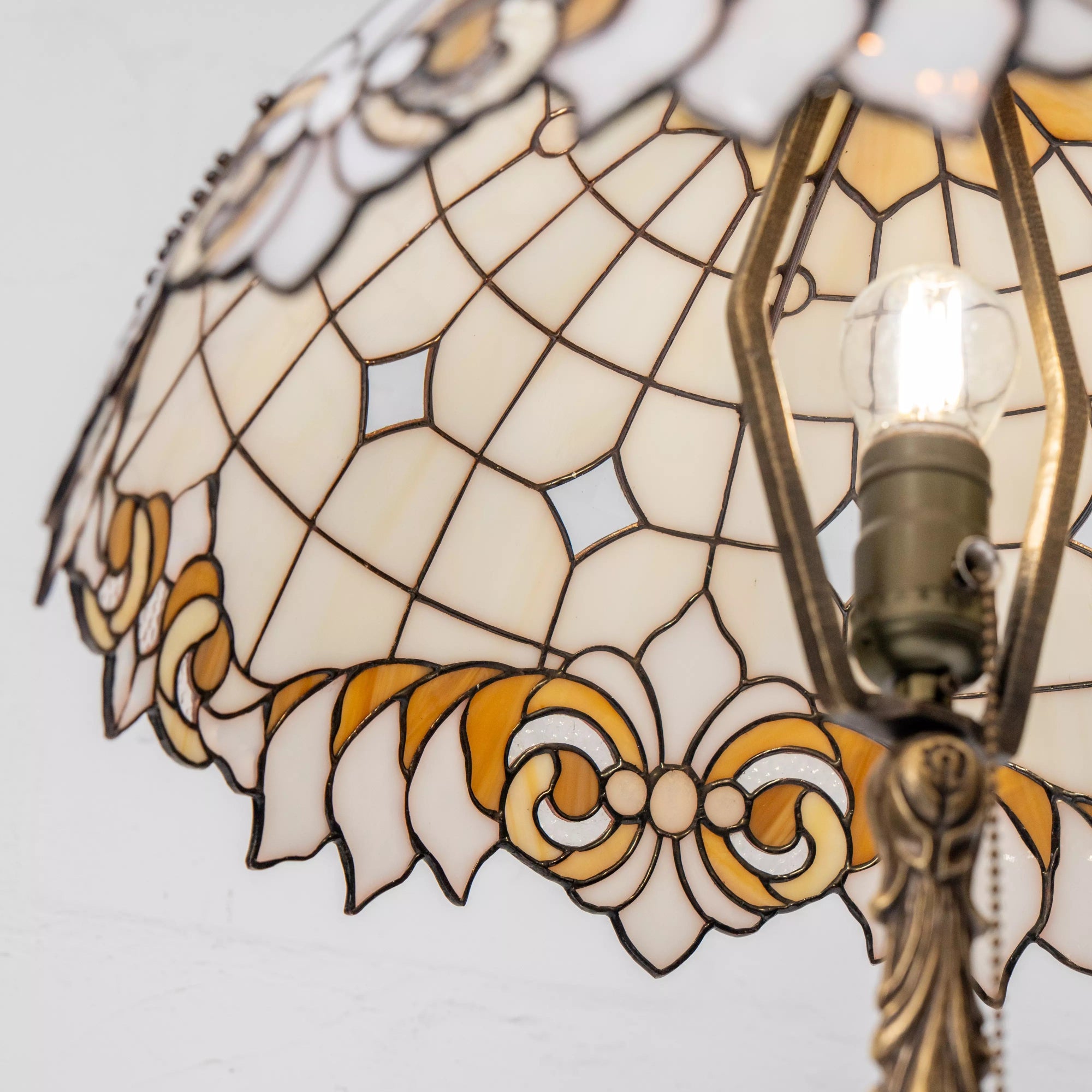 Inside view of stained glass shade showing bulb and intricate leaded glass patterns