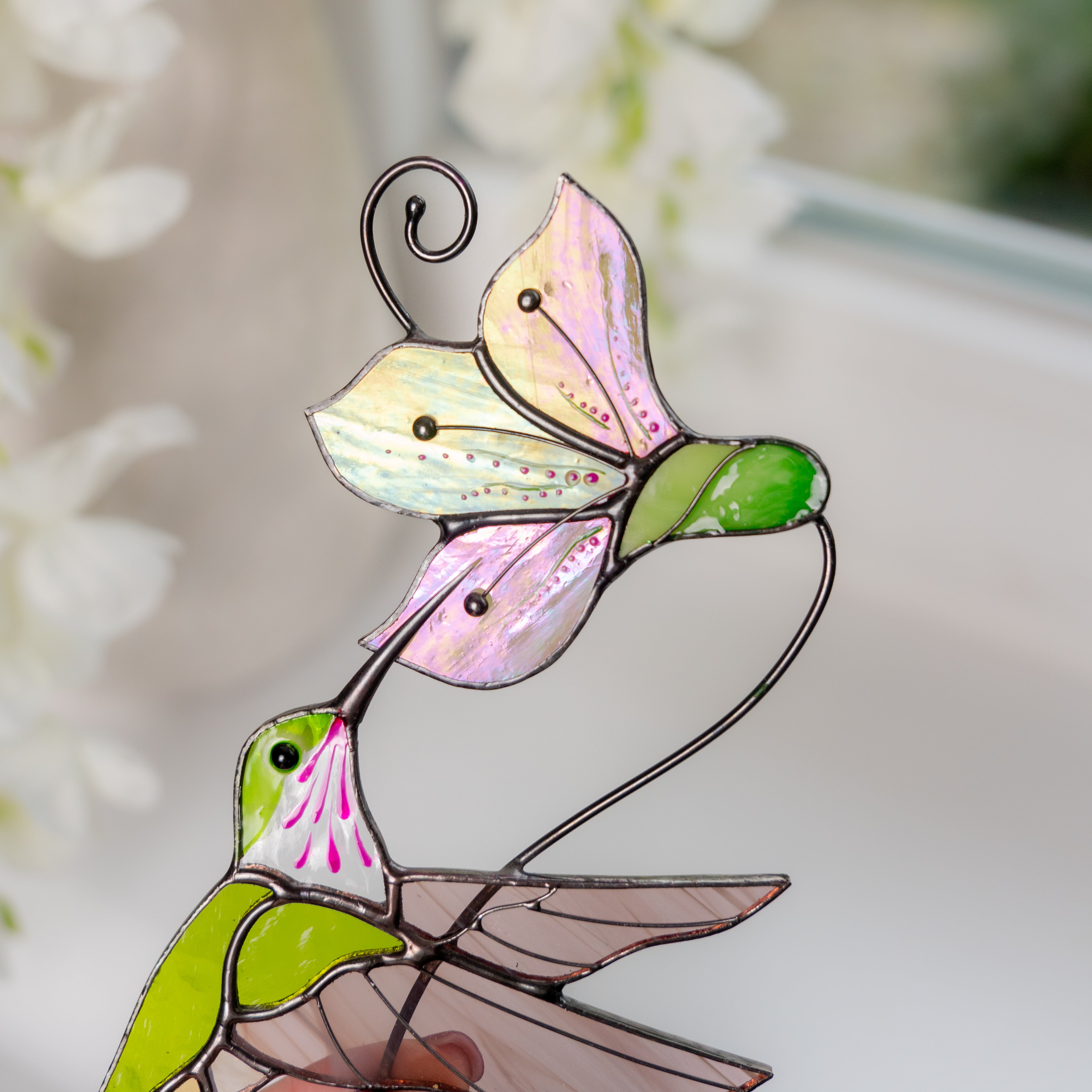 Close-up of the flower in the suncatcher with shimmering glass petals and bead accents