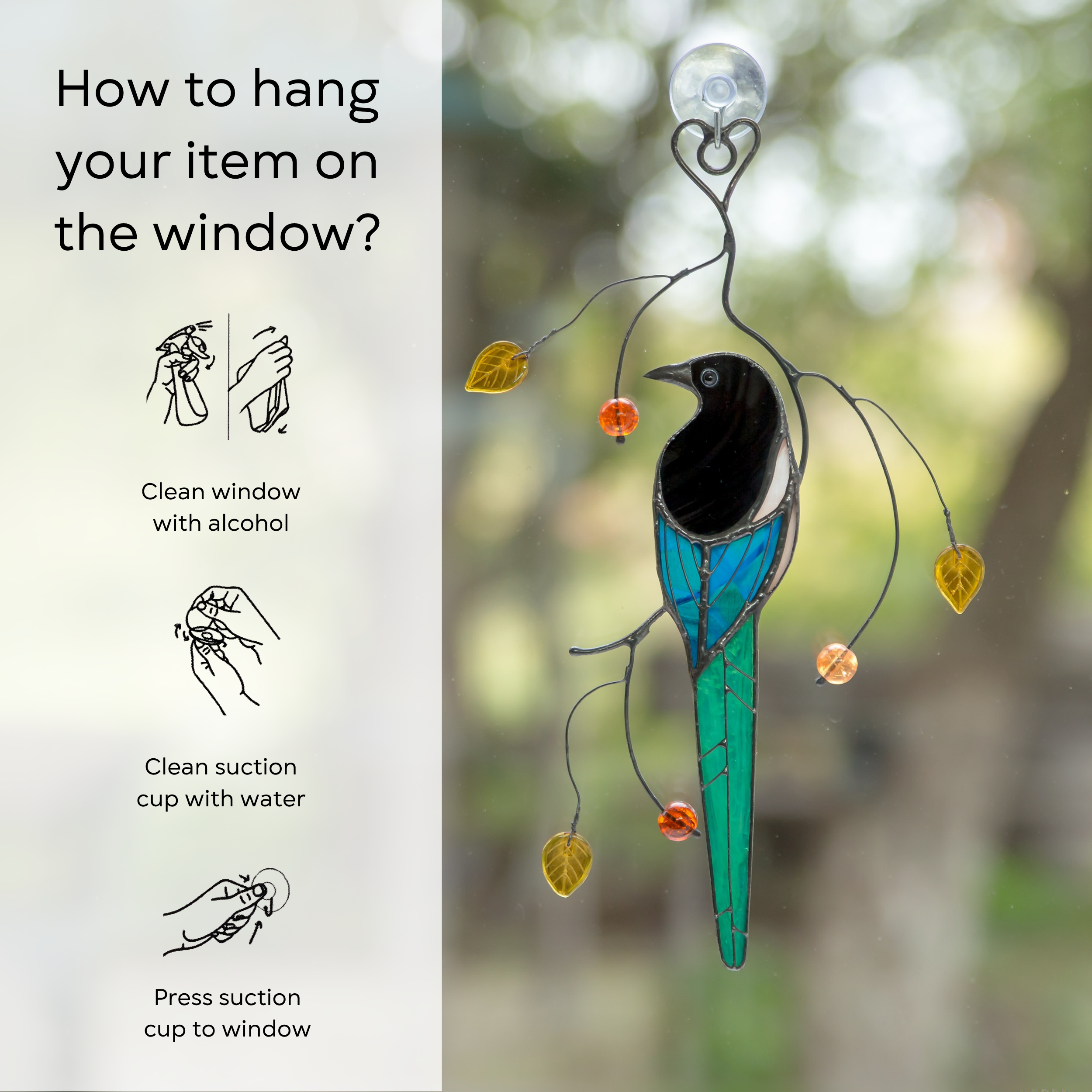 Stained glass magpie decor hanging on a window using a suction cup, with step-by-step instructions: clean window and suction cup, press a cup to the surface.