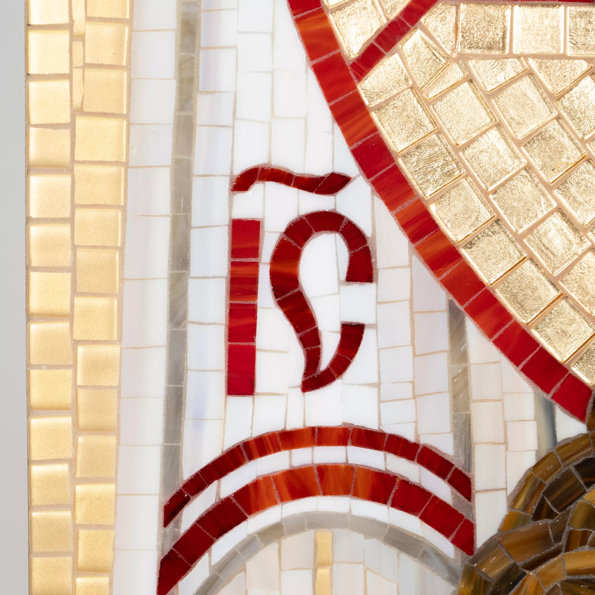 Stained glass mosaic design with red and gold patterns on a white background