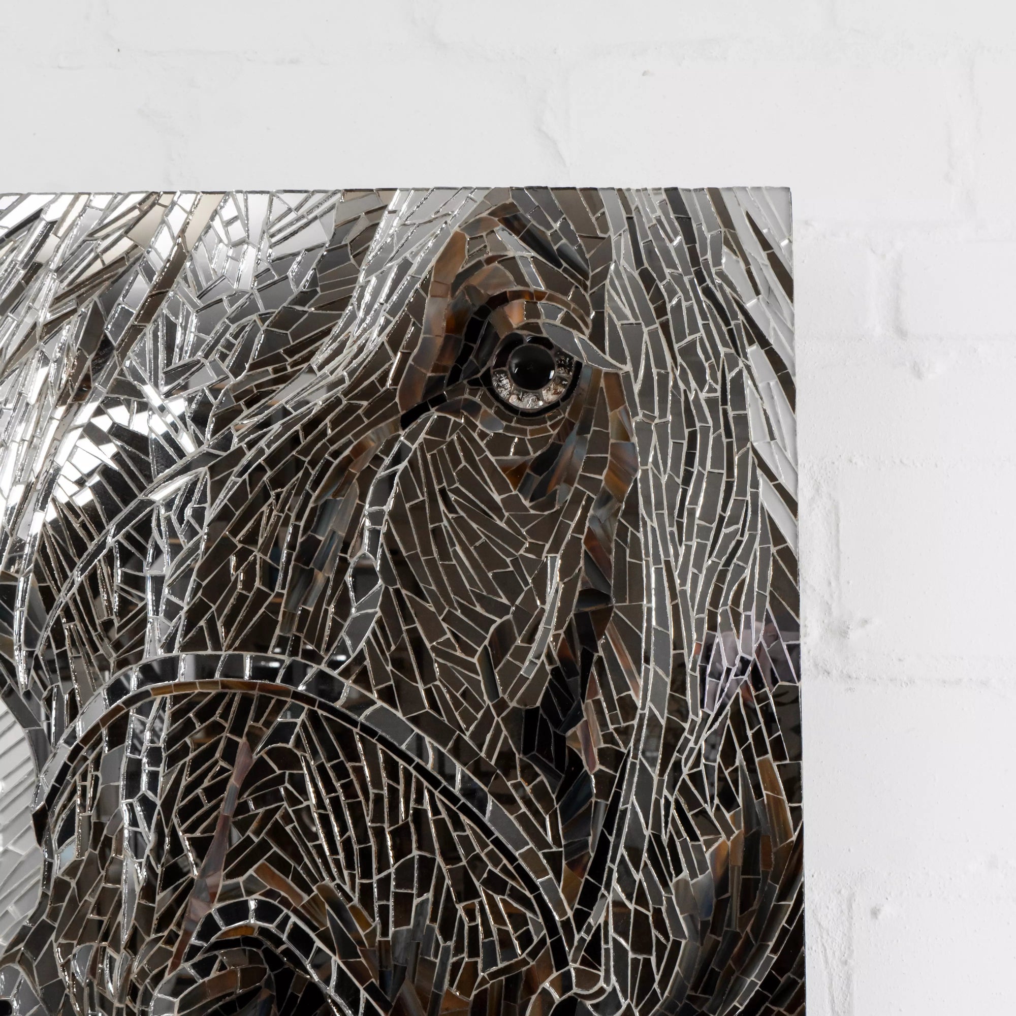 Close-up of a horse’s eye made of glass mosaic tiles in grey and brown tones