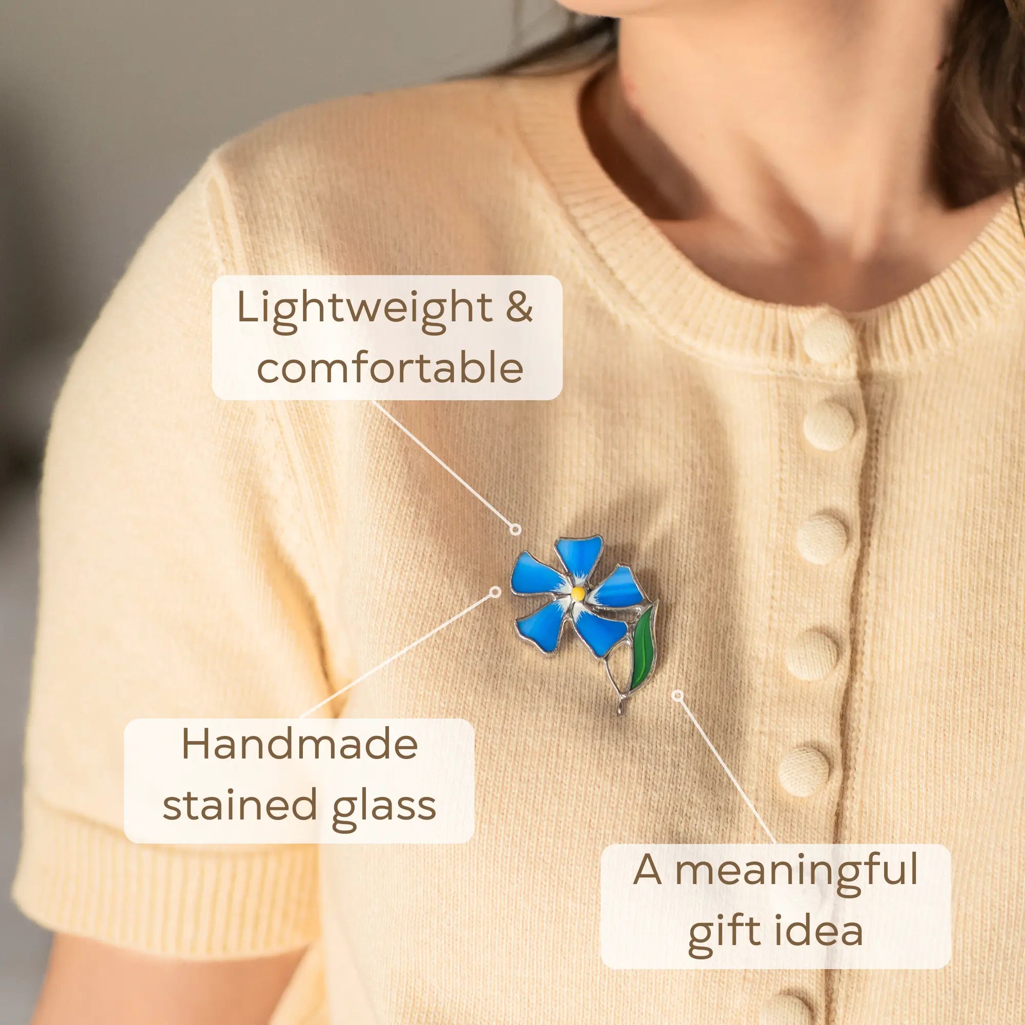 Women wearing a blue periwinkle flower brooch, choose it as a meaningful gift for loved one