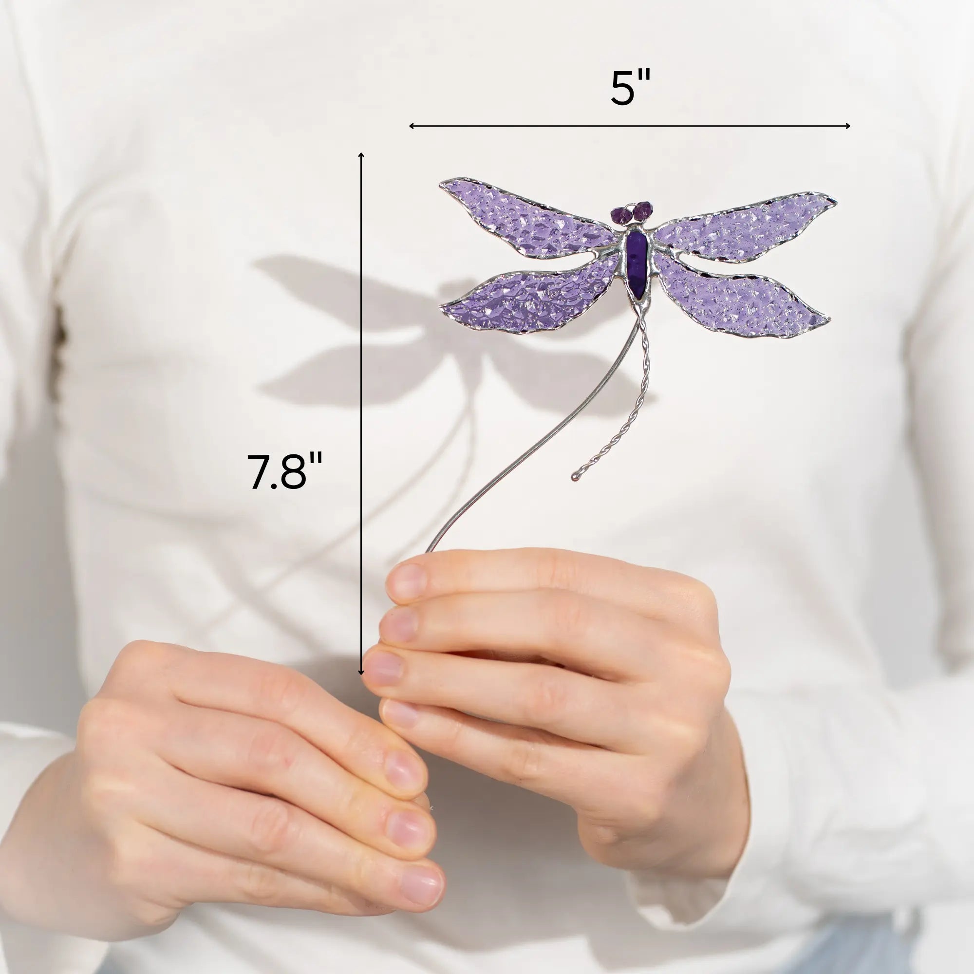 Purple dragonfly stained glass plant stake held by a person with measurements indicated 5 x 7.8 inches