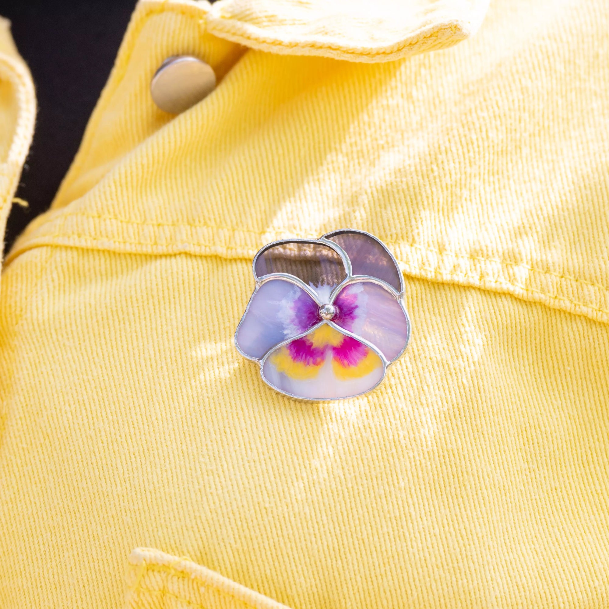 Floral brooch on a yellow denim jacket