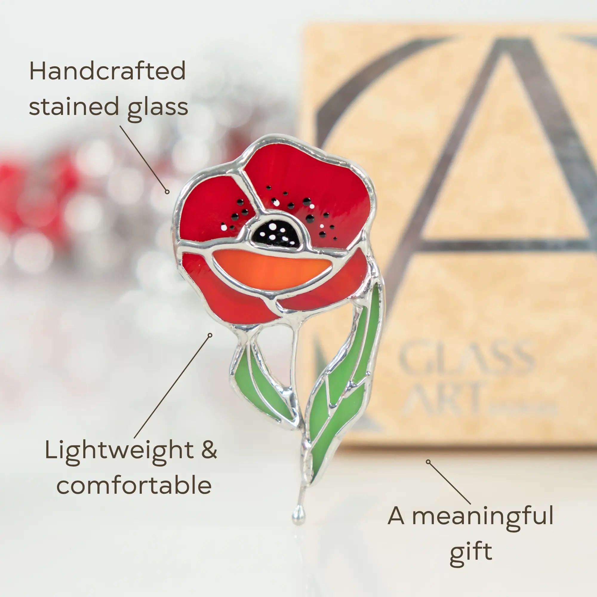 Red poppy stained glass art piece with text highlighting features on a blurred background