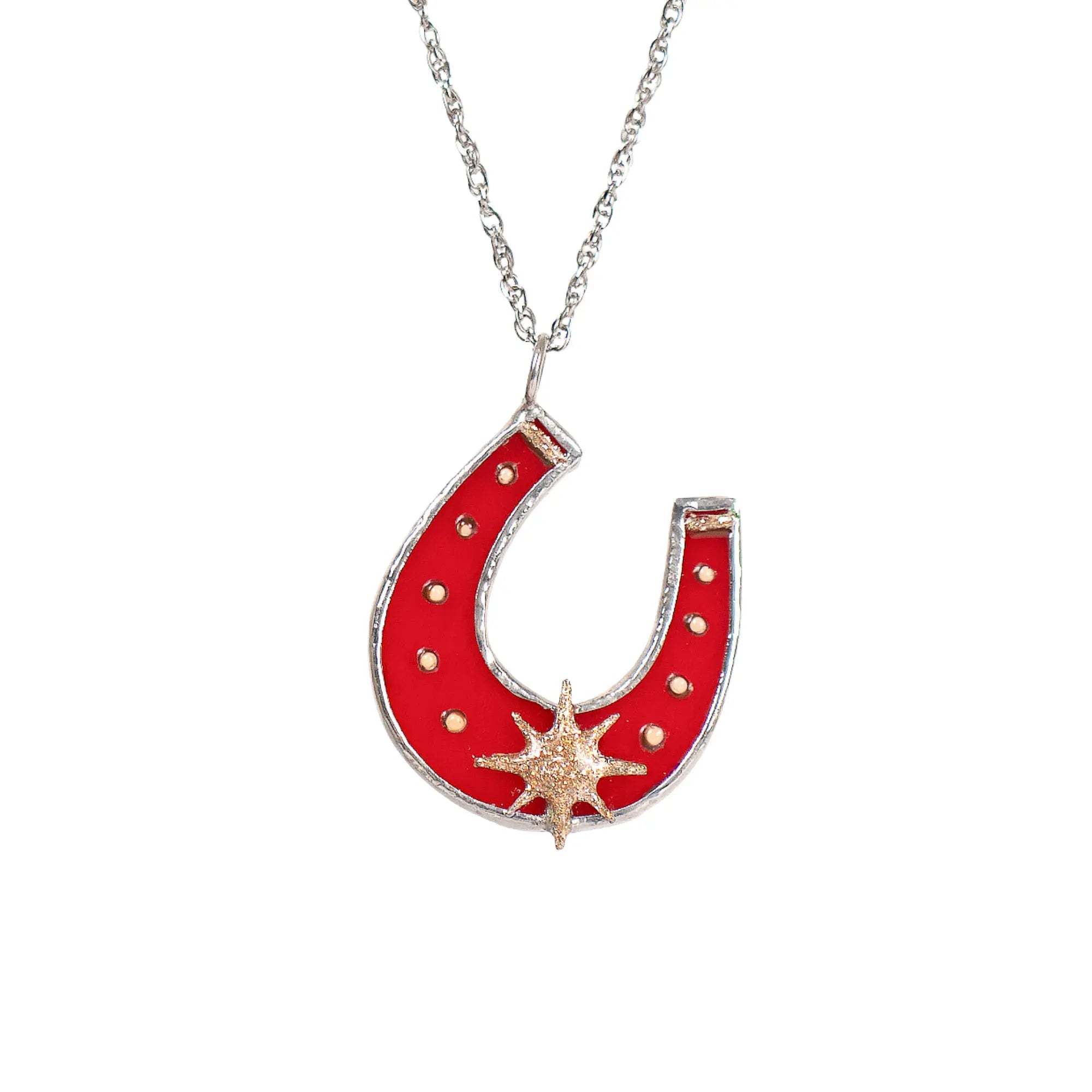 Red horseshoe stained glass pendant with star design on a silver chain against a white background