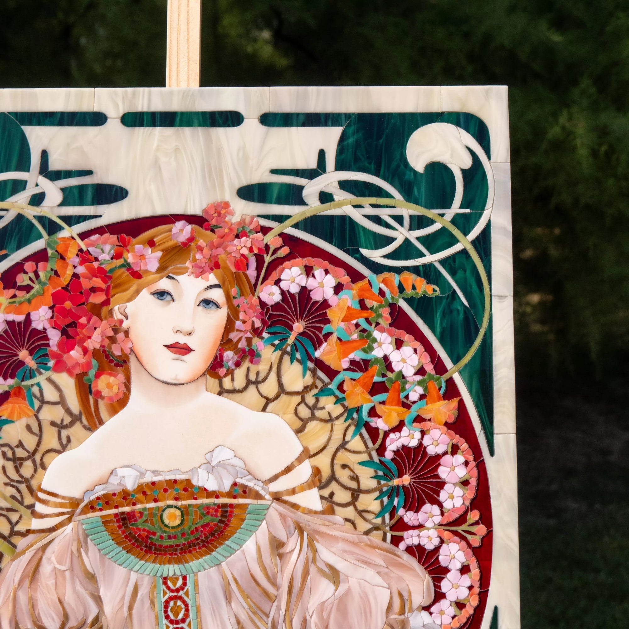 Upper section of Riviera mosaic panel with Art Nouveau curves, deep green glass background, and ornamental flowing lines.