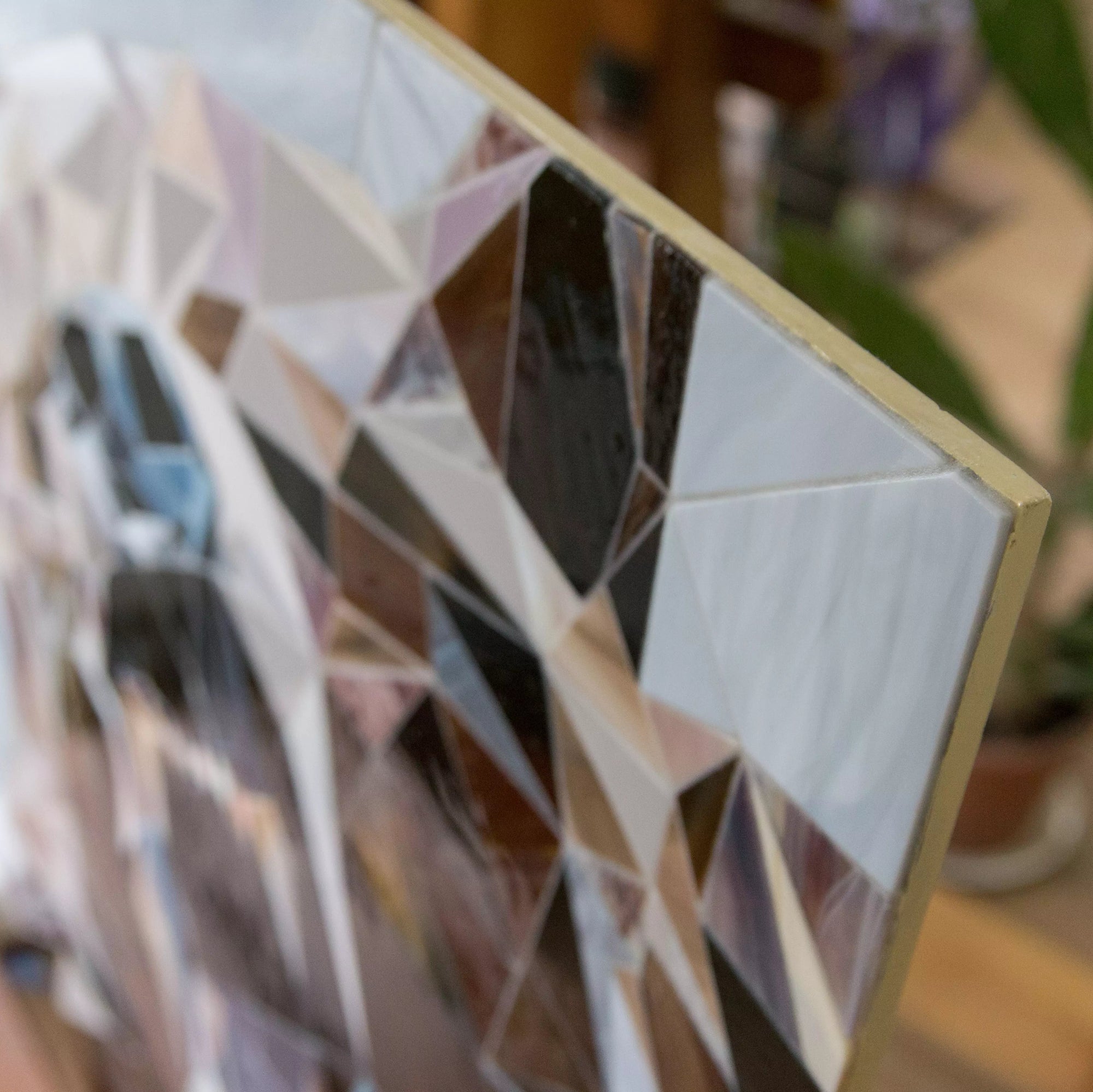 Close-up of the stained glass mosaic’s corner, showing edge finish and triangular glass pattern